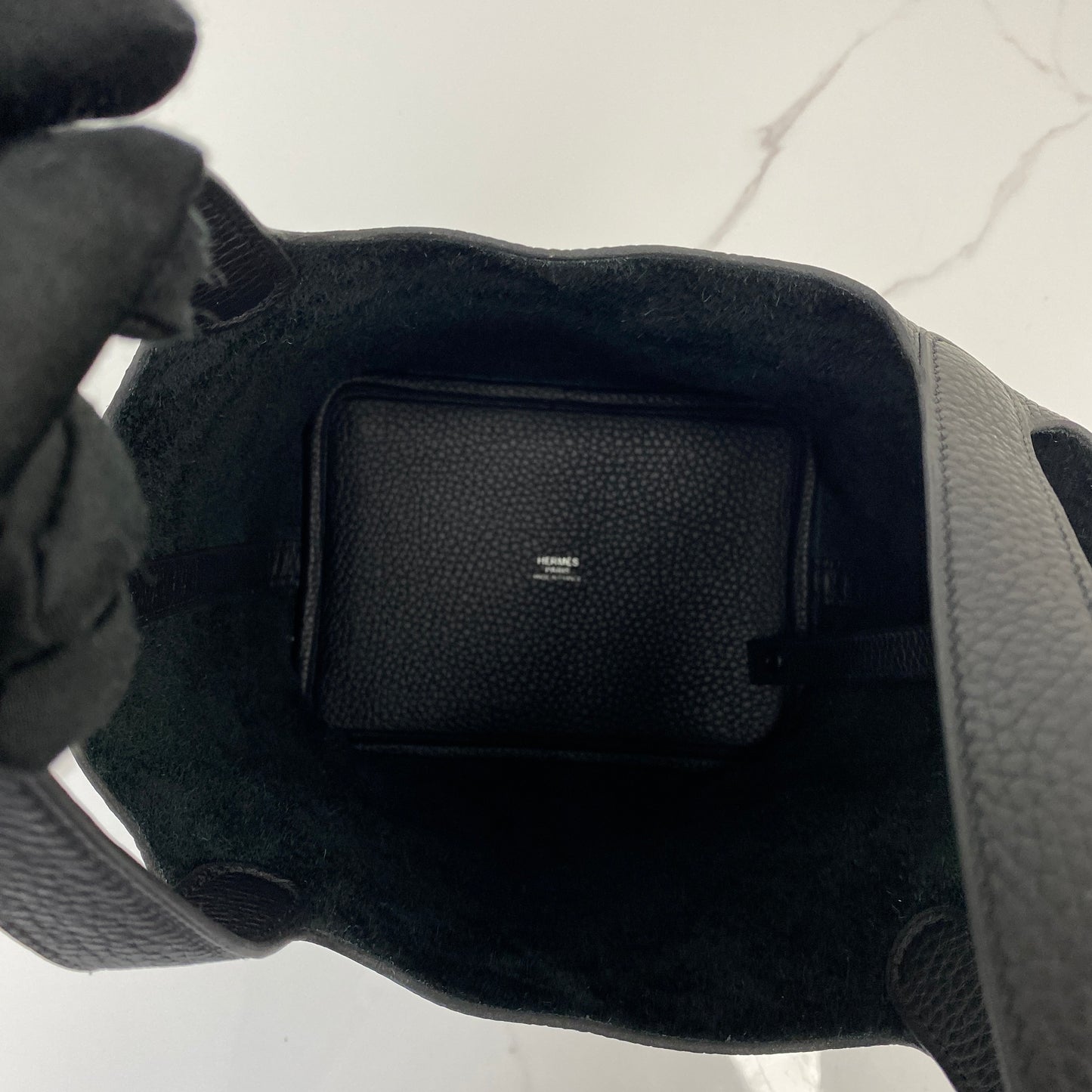 Interior of the Hermès Picotin 18 showing the suede lining and stamped pocket