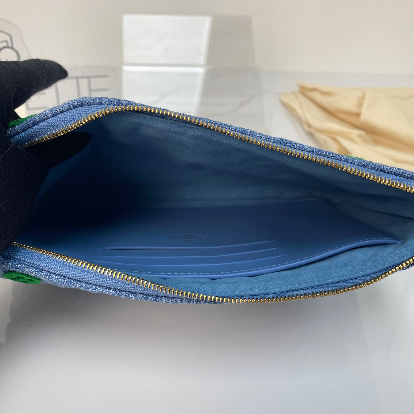 Louis Vuitton New Wave denim pouch shown with its dustbag