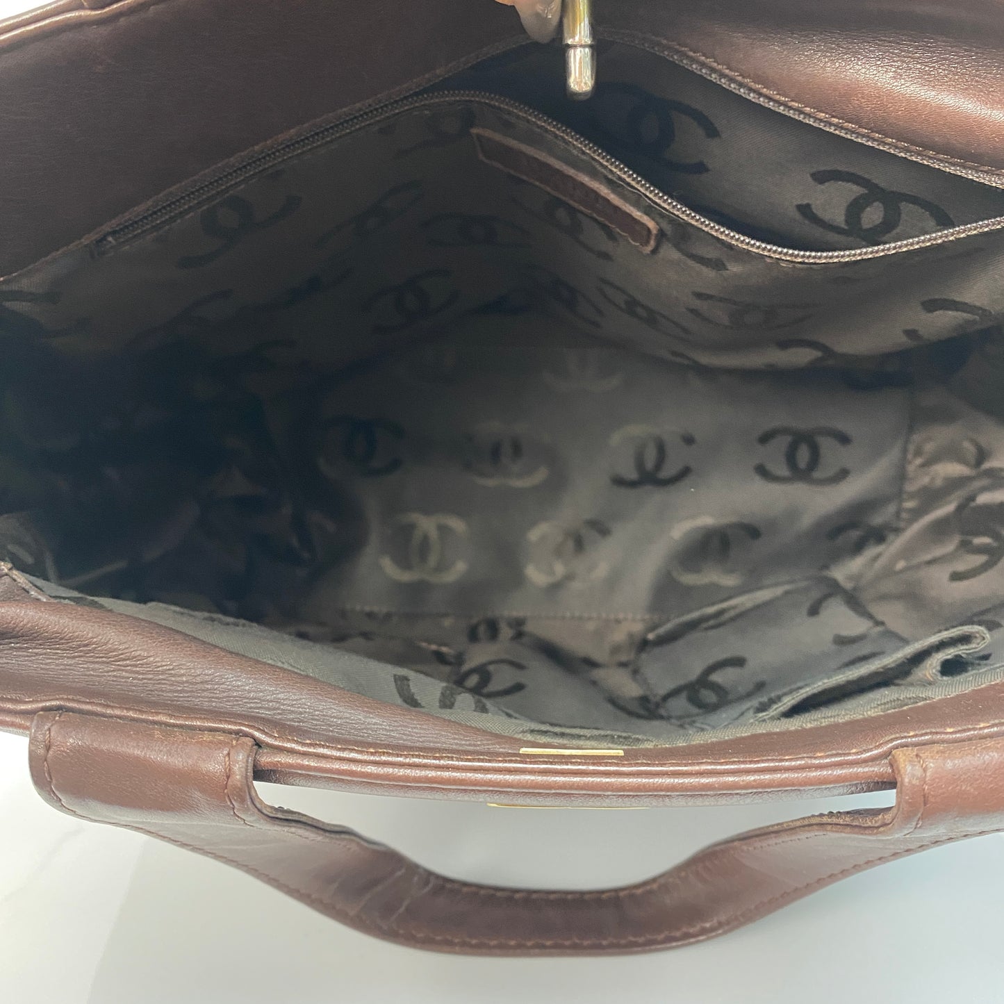 Chanel vintage tote shown with its strap and Entrupy certification
