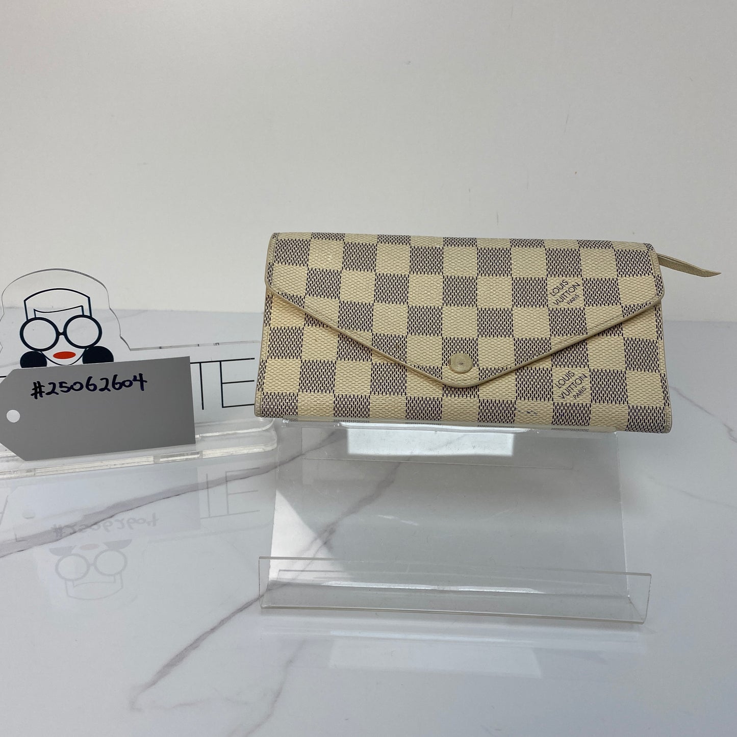 Front view of the white Louis Vuitton Sarah Wallet