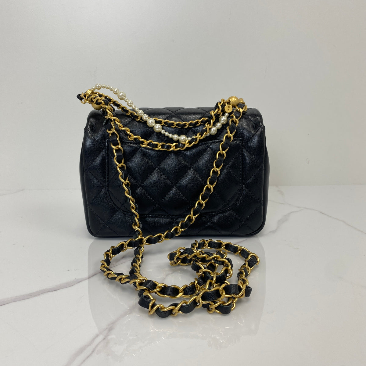 Chanel Pearl Twist Mini Classic Flap Bag, black lambskin, gold-tone hardware, pearl detail — detail view 3