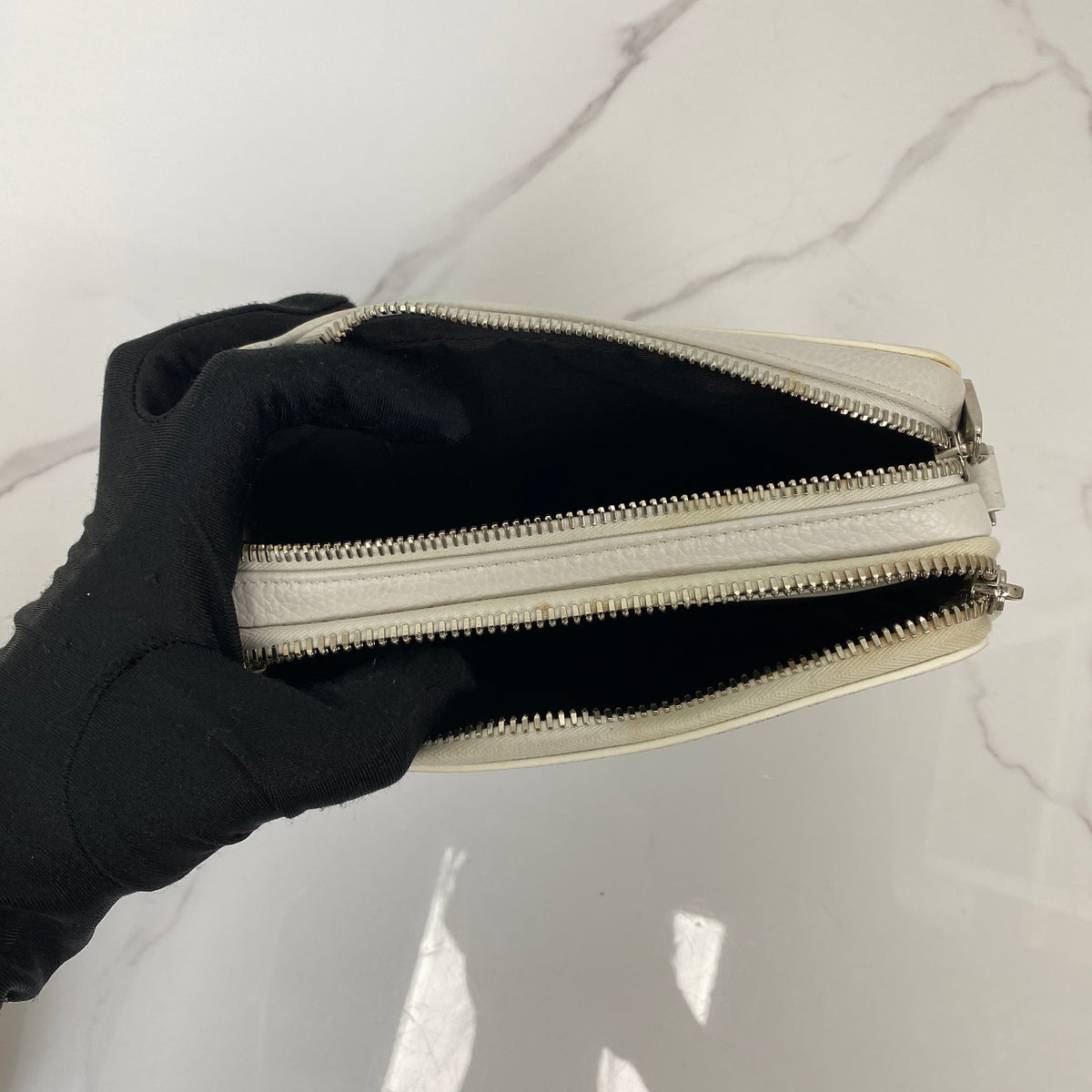 Christian Dior x Daniel Arsham Newspaper Messenger Bag, white and black newspaper-print calfskin, silver-tone hardware — detail view 5