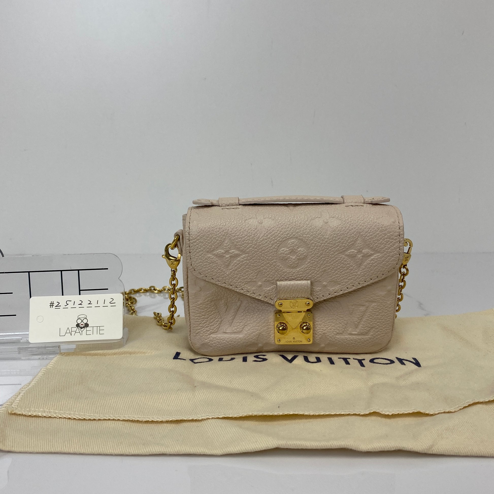 Front view of the cream LV Micro Pochette Metis