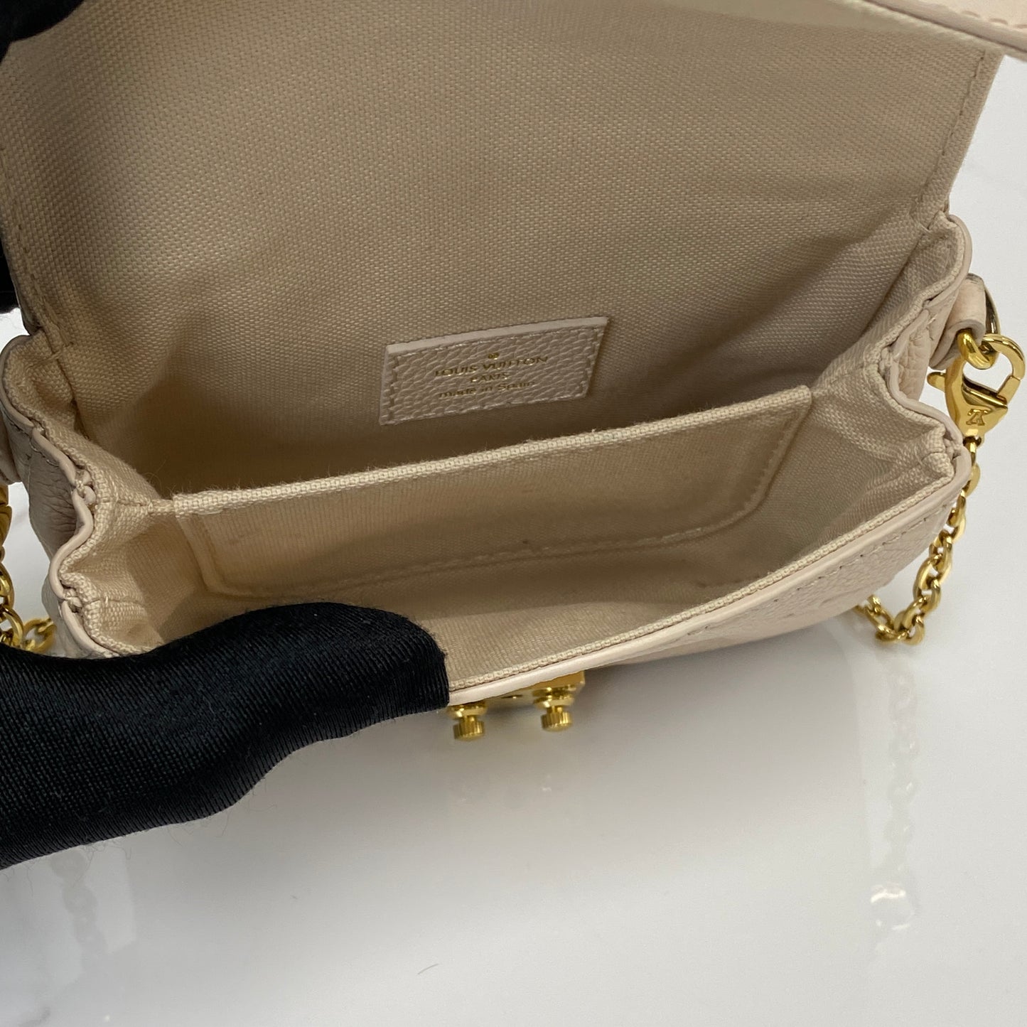 Micro Pochette Metis shown with its chain strap and dustbag