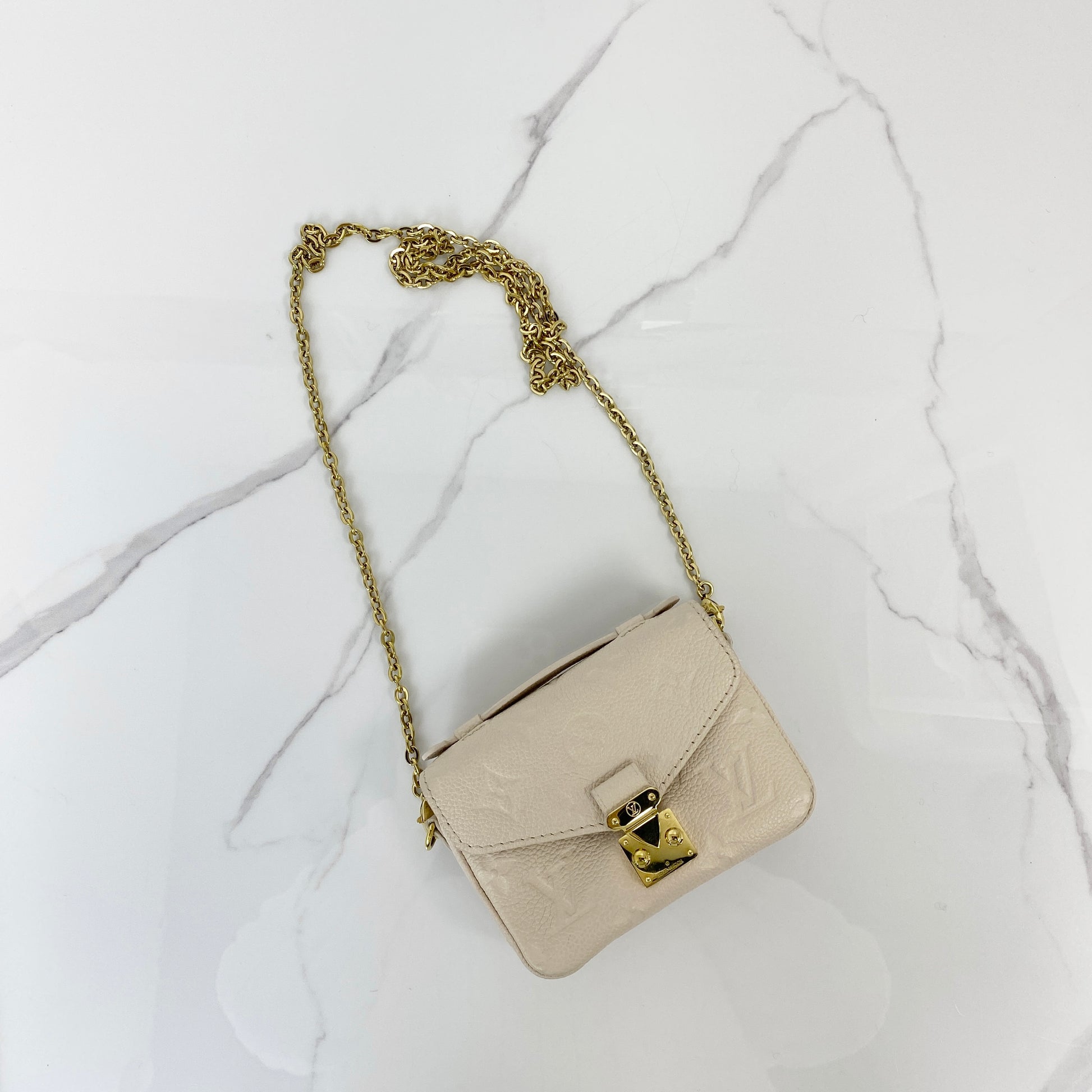 Louis Vuitton Micro Pochette Metis in cream embossed monogram leather with chain strap