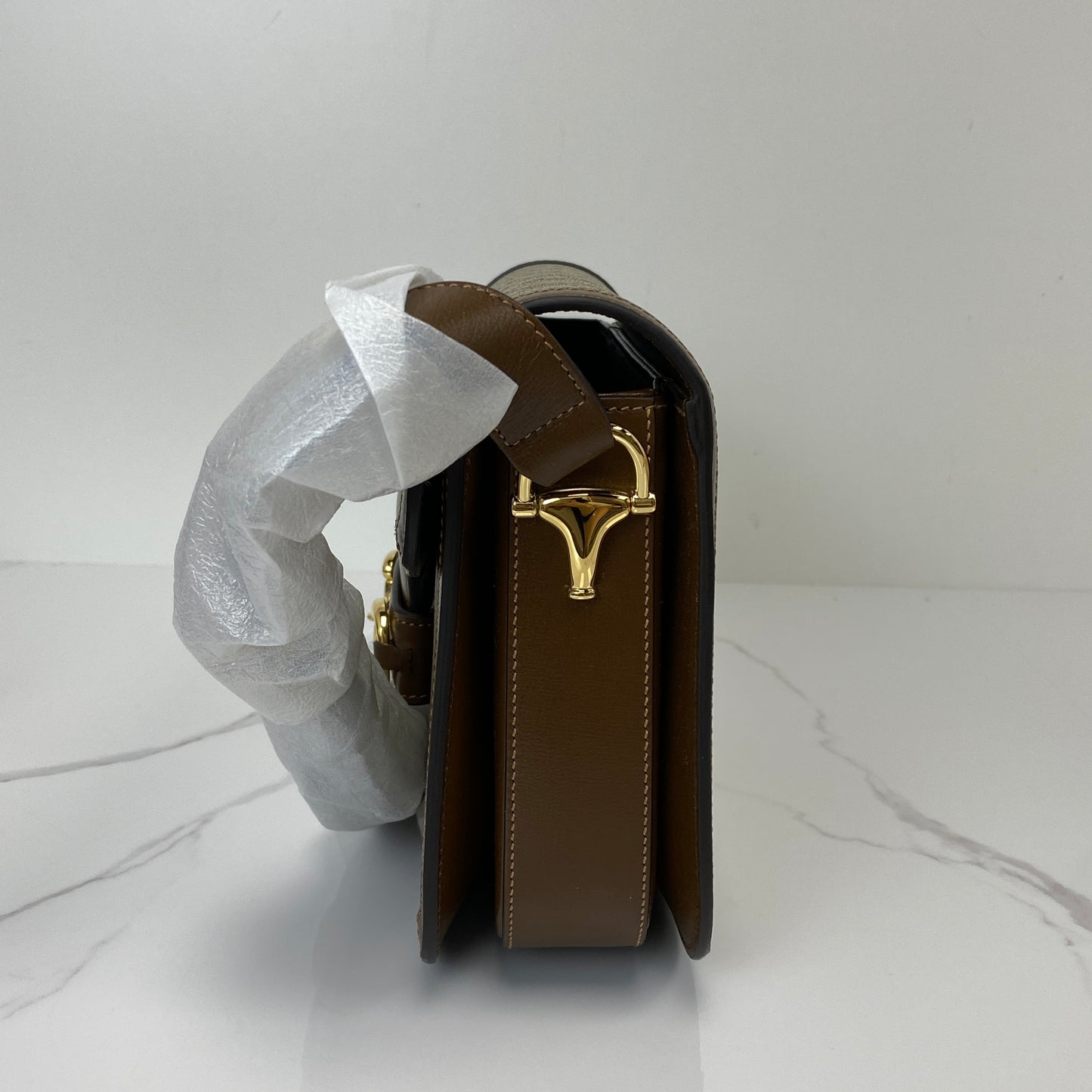 Side profile of the Gucci Horsebit 1955 showing the gold-tone hardware