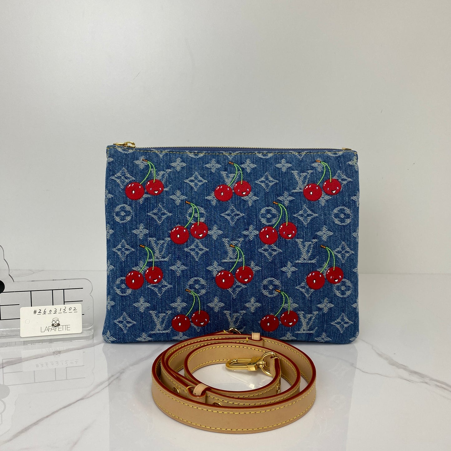 Louis Vuitton Cherry Coussin shown with its included adjustable strap