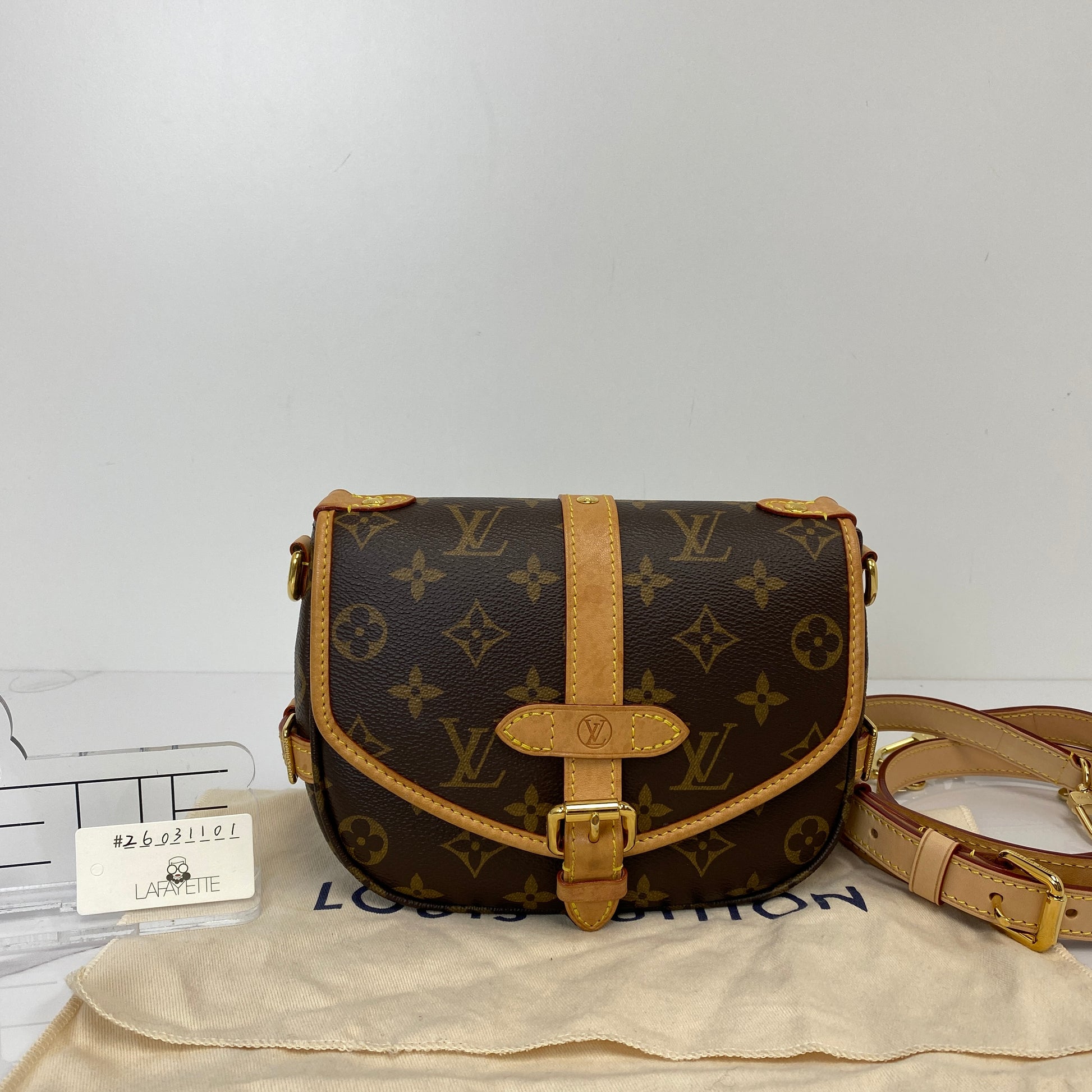 Louis Vuitton Saumur BB shown with its dustbag and both included straps