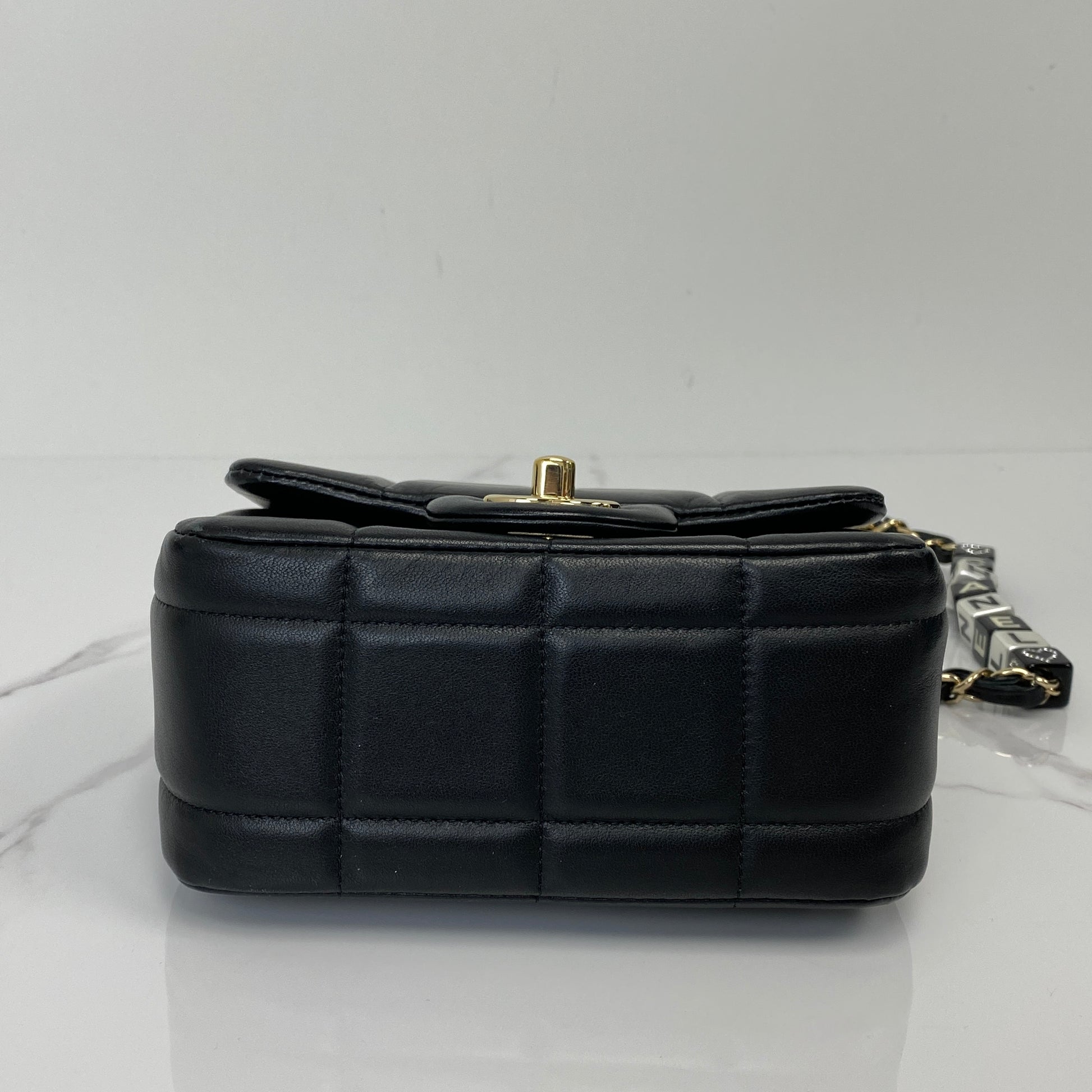 Base of the Chanel 23C mini flap in black lambskin