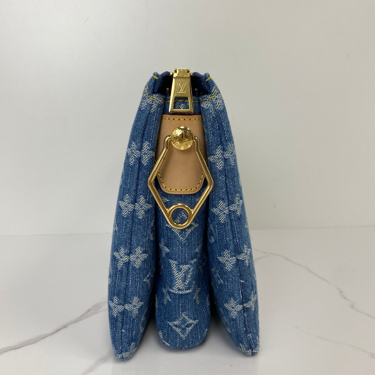 Side profile of the Louis Vuitton Cherry Coussin with gold-tone clasp