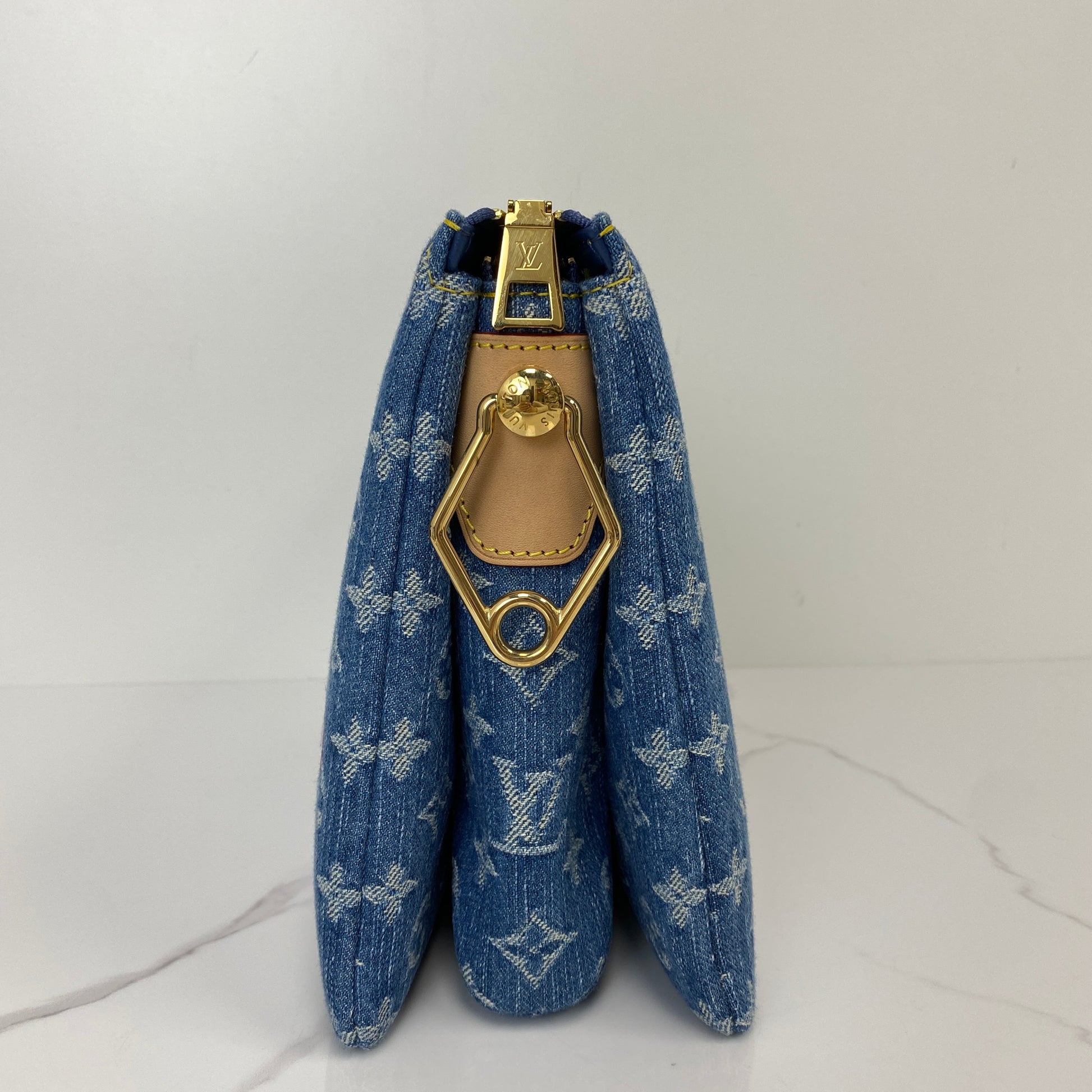 Side profile of the Louis Vuitton Cherry Coussin with gold-tone clasp