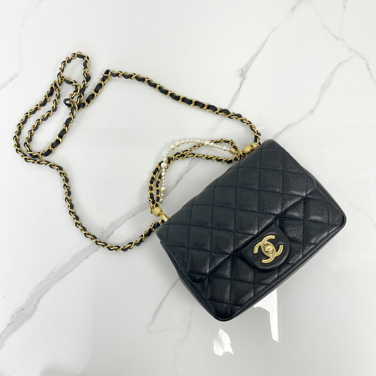 Chanel Pearl Twist Mini Classic Flap Bag, black lambskin, gold-tone hardware, pearl detail — front view