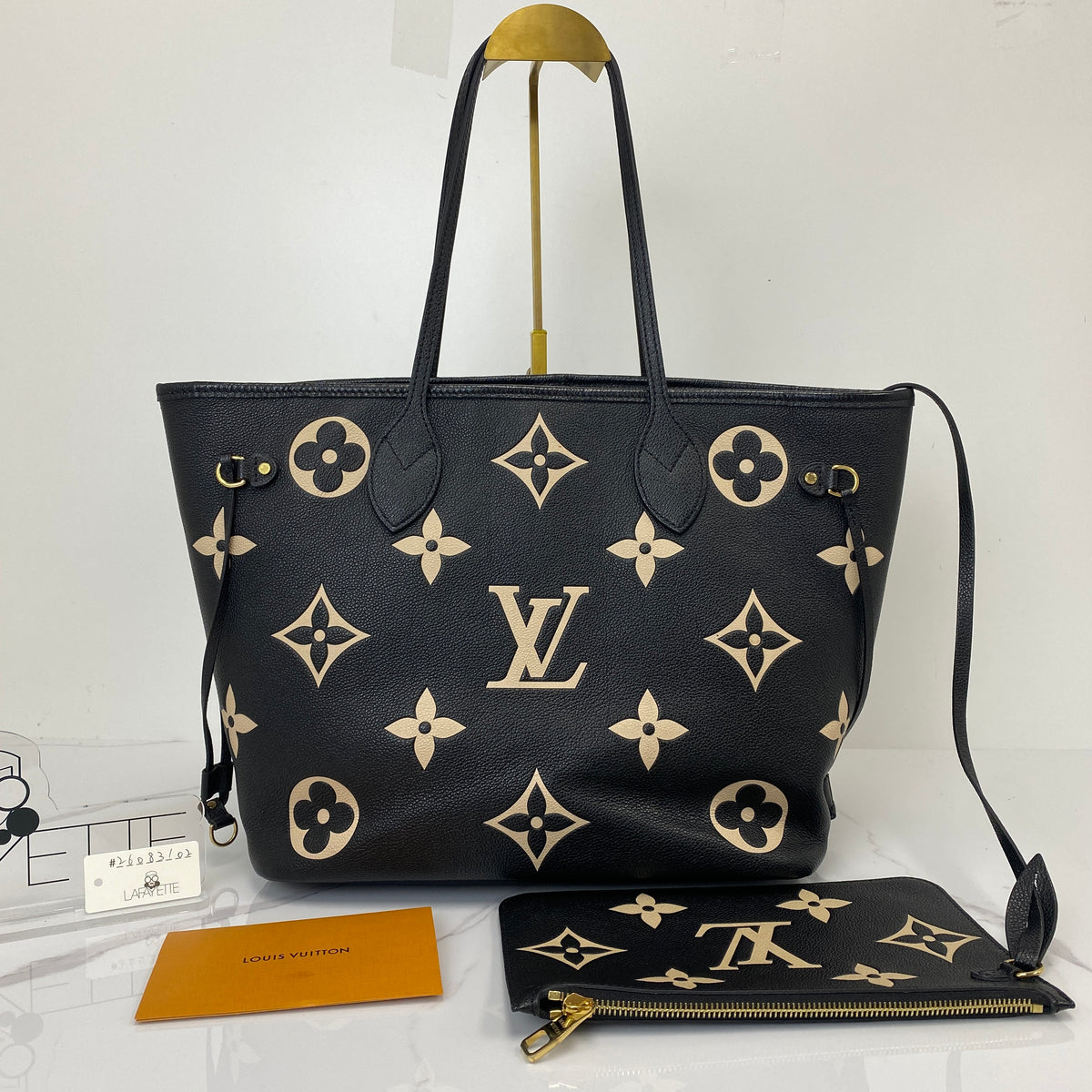 Louis Vuitton Neverfull MM, black Monogram Empreinte leather, gold-tone hardware — detail view 3