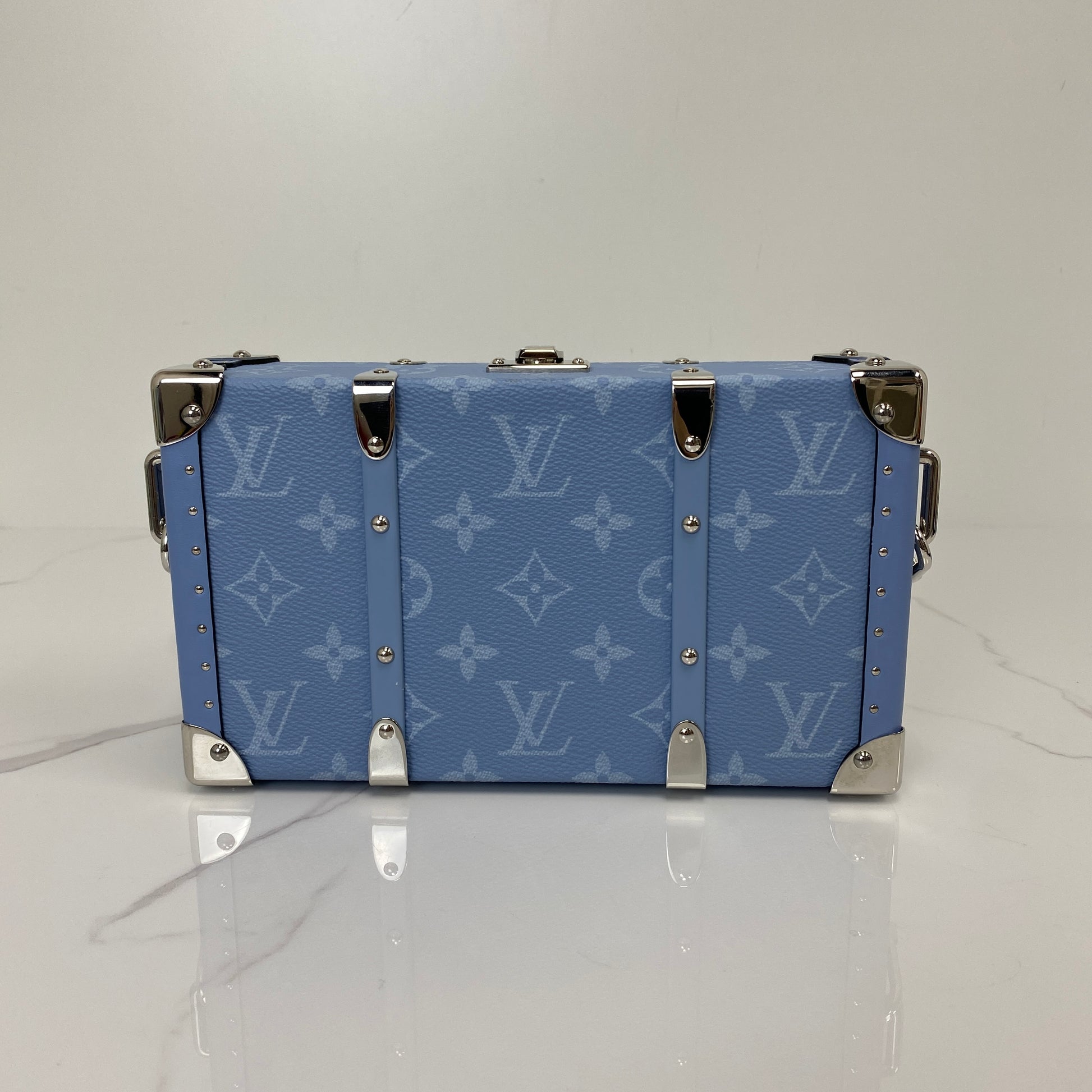 Front view of the denim blue Louis Vuitton Wallet Trunk showing the Monogram pattern