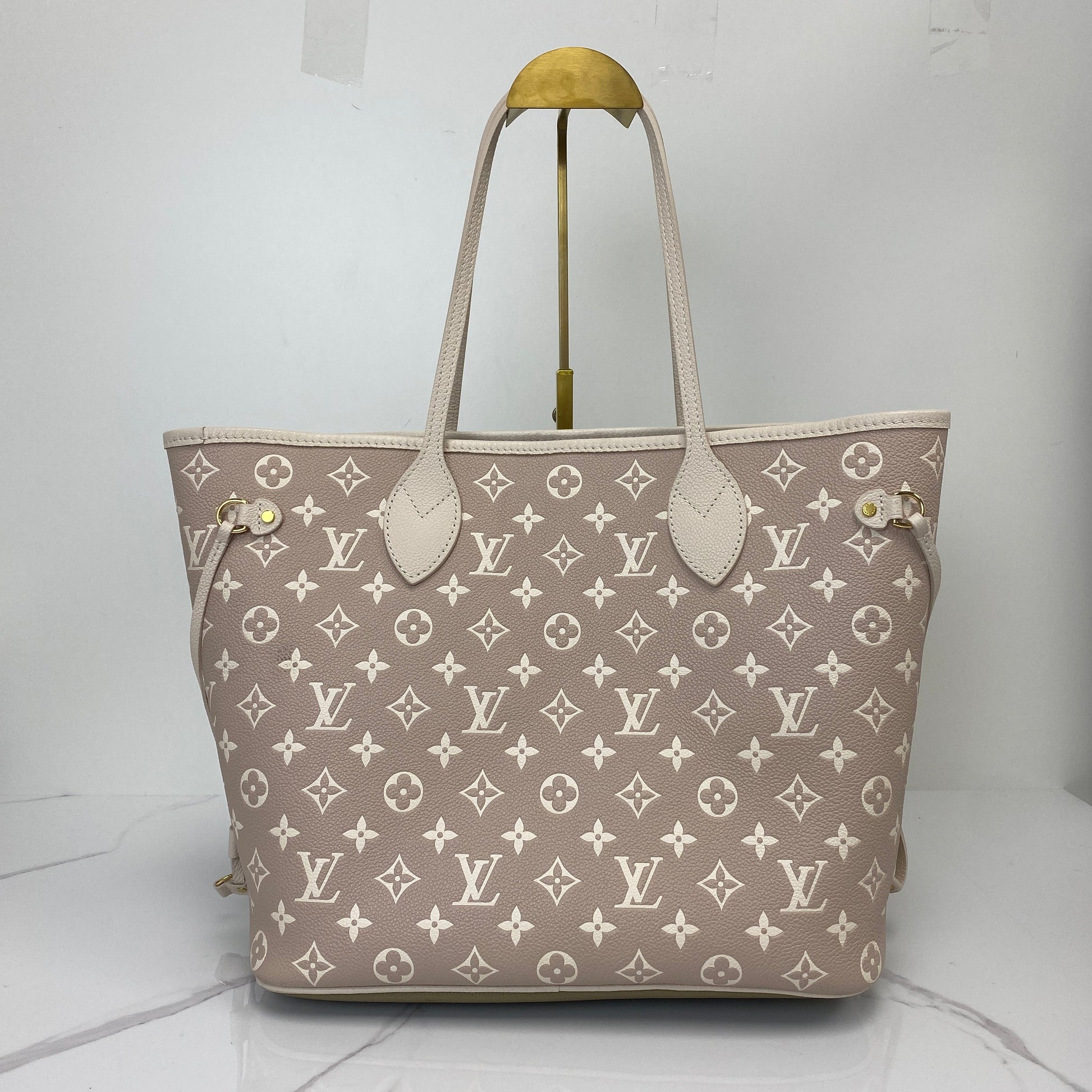 Front view of the Louis Vuitton Neverfull MM showing the embossed Monogram pattern