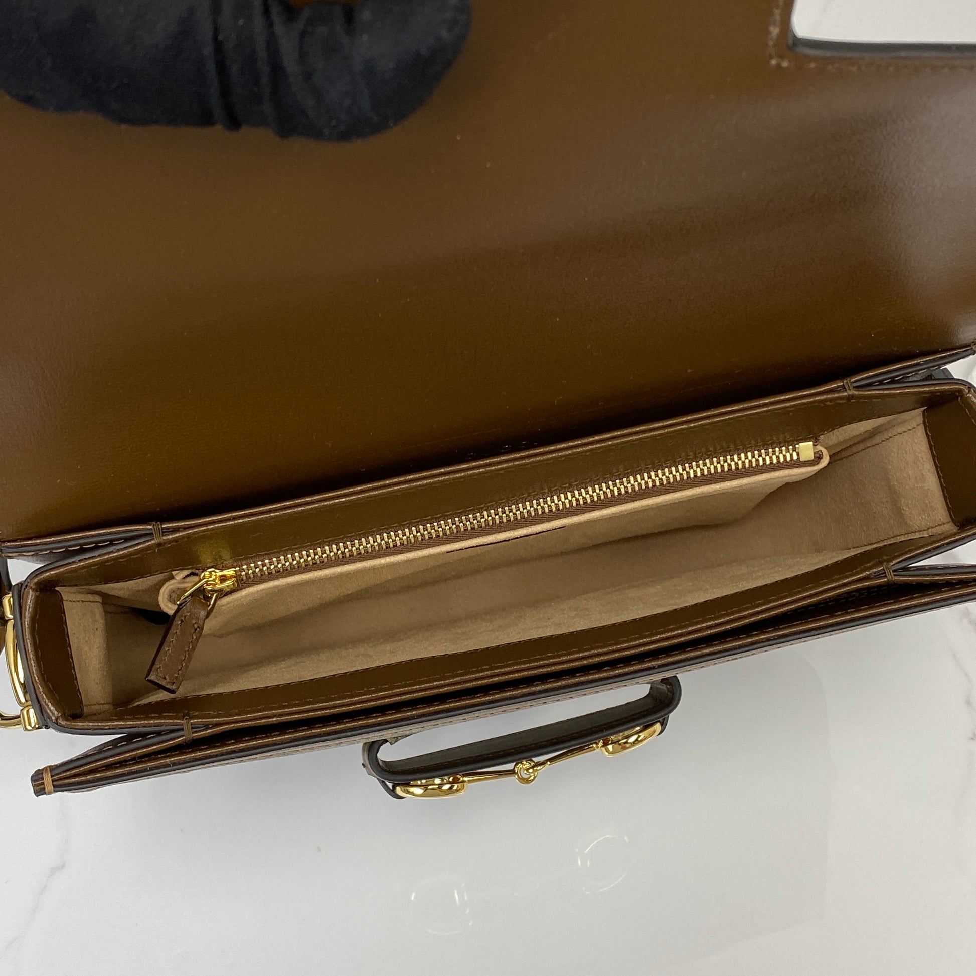Interior of the Gucci 1955 Horsebit bag with zip pocket