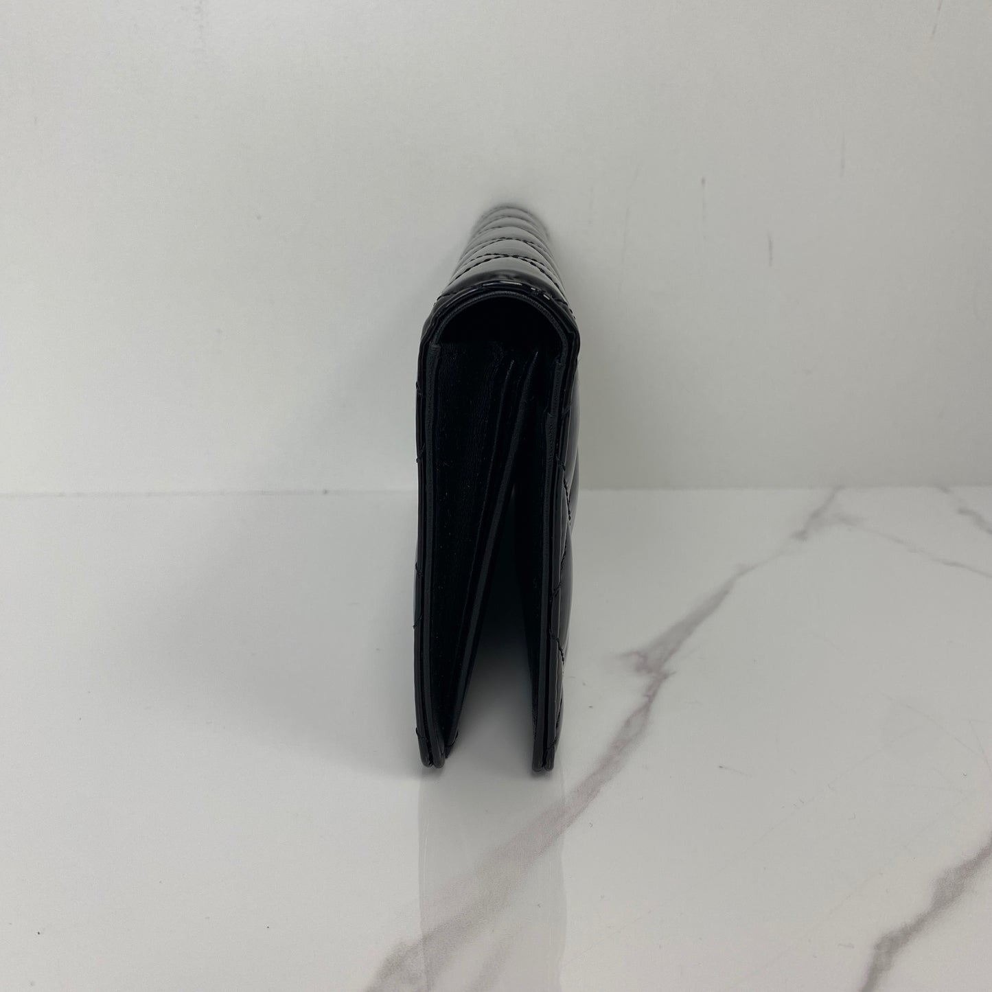 Front view of the black patent Chanel long wallet