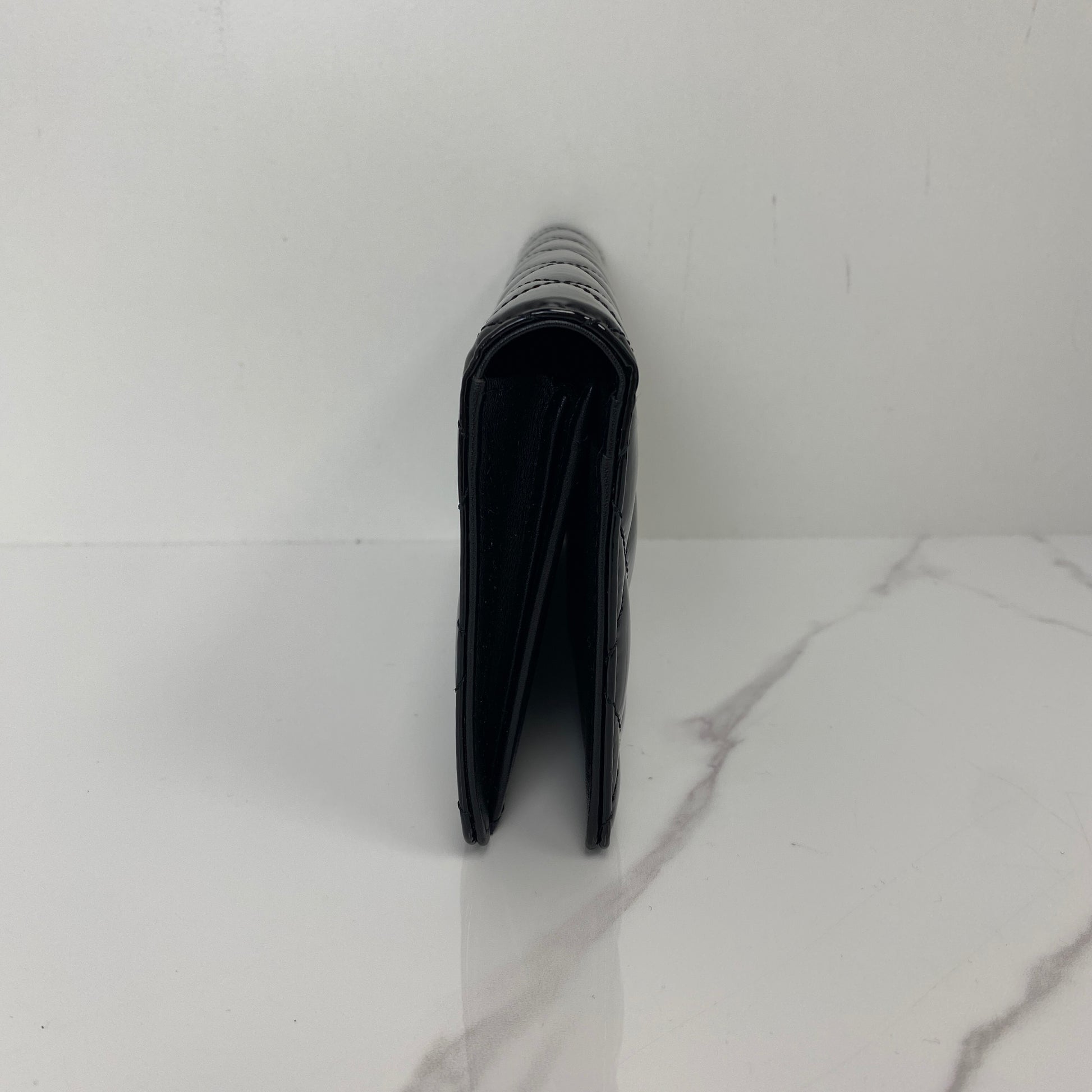 Front view of the black patent Chanel long wallet