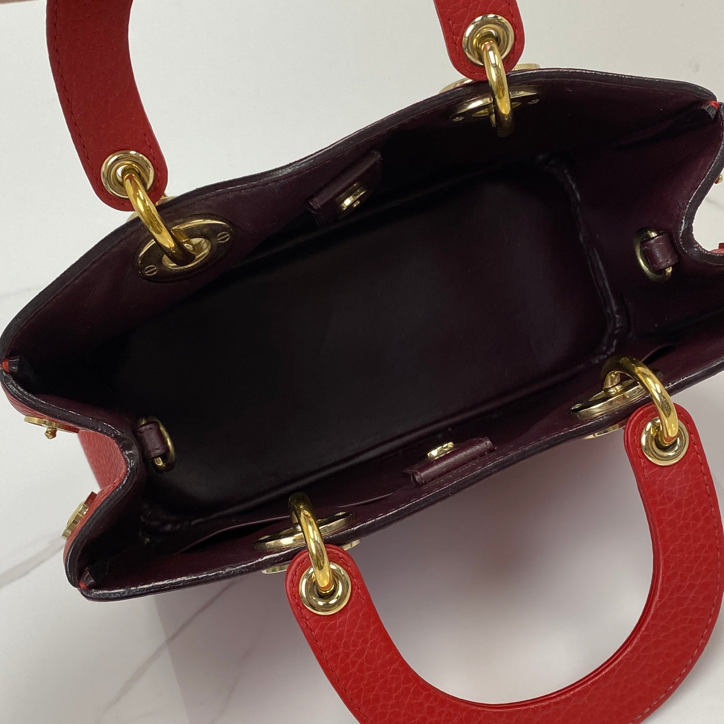 Mini Diorissimo shown with its strap, dustbag and box