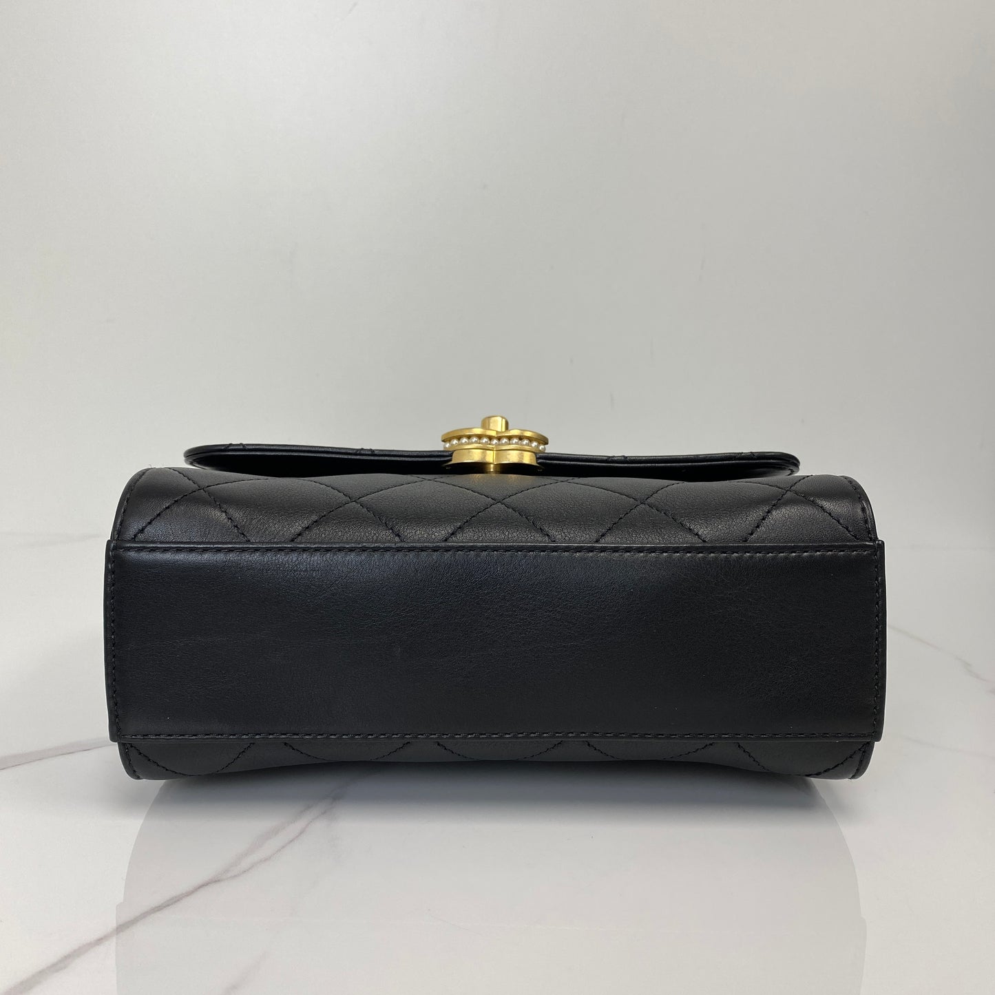 Base of the Chanel quilted lambskin top handle flap bag