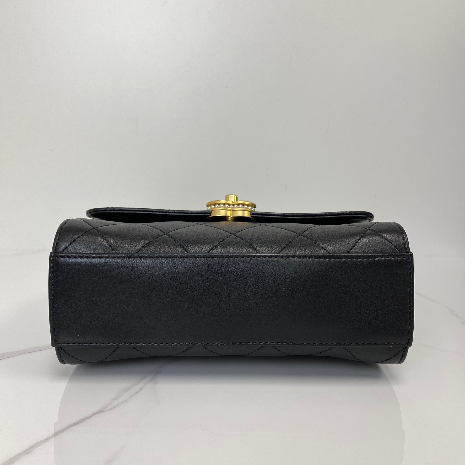 Base of the Chanel quilted lambskin top handle flap bag