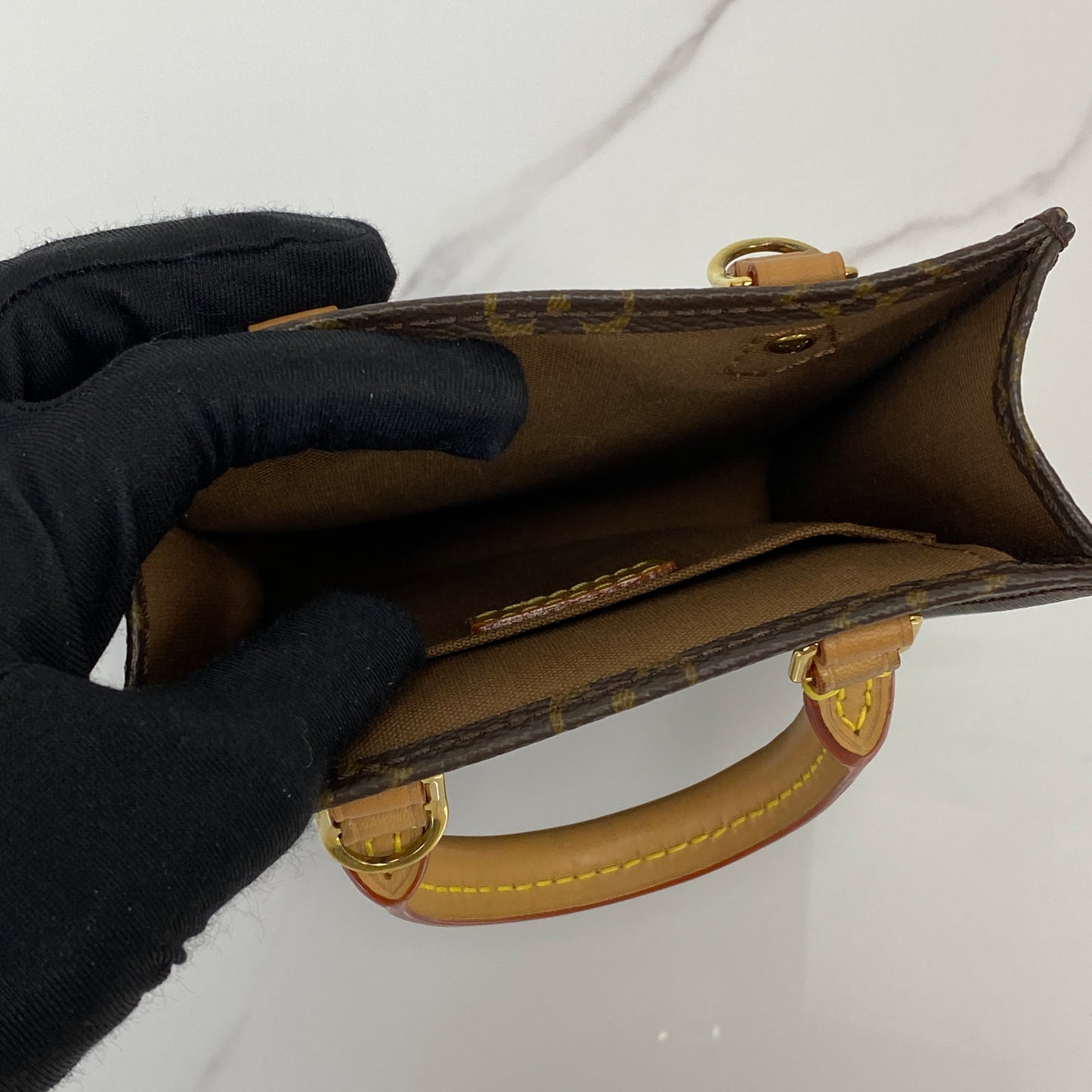 Petit Sac Plat shown with its strap and dustbag