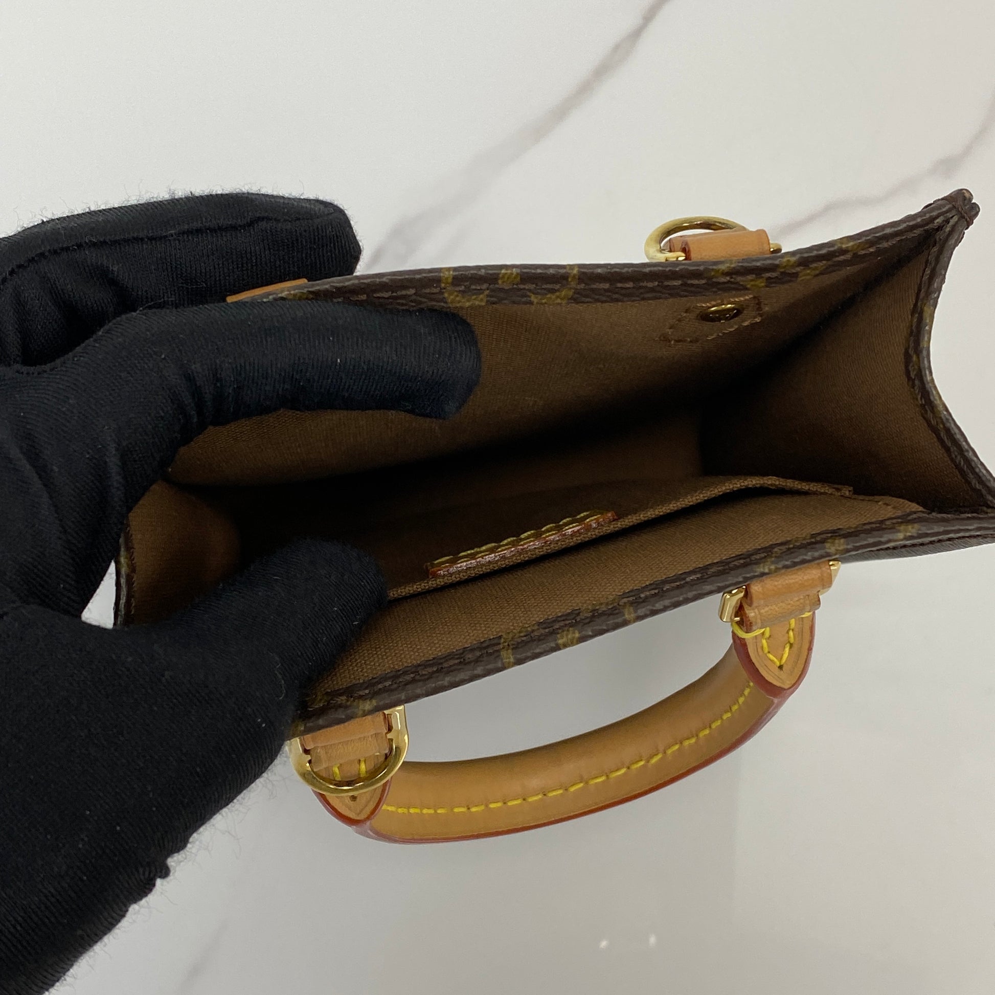 Petit Sac Plat shown with its strap and dustbag
