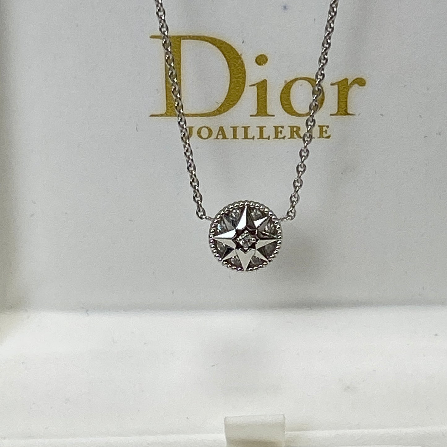 Dior Rose Des Vents necklace shown with its box and certificate