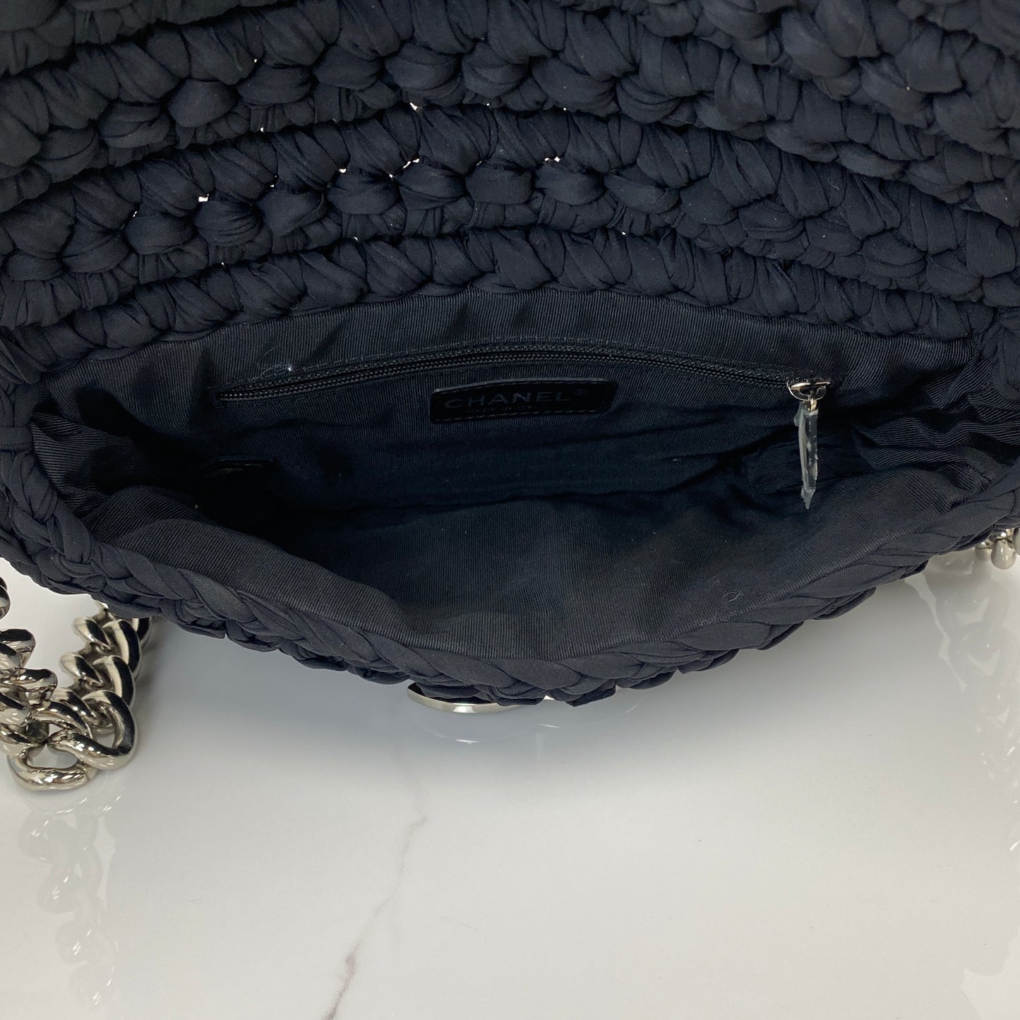 Chanel tweed flap bag shown with its dustbag