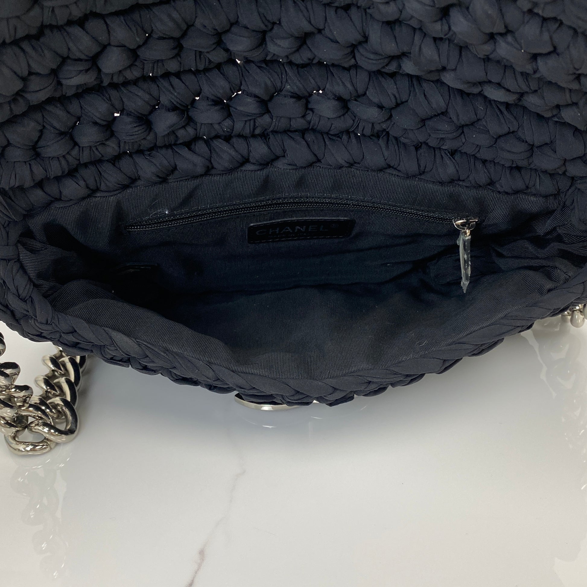 Chanel tweed flap bag shown with its dustbag