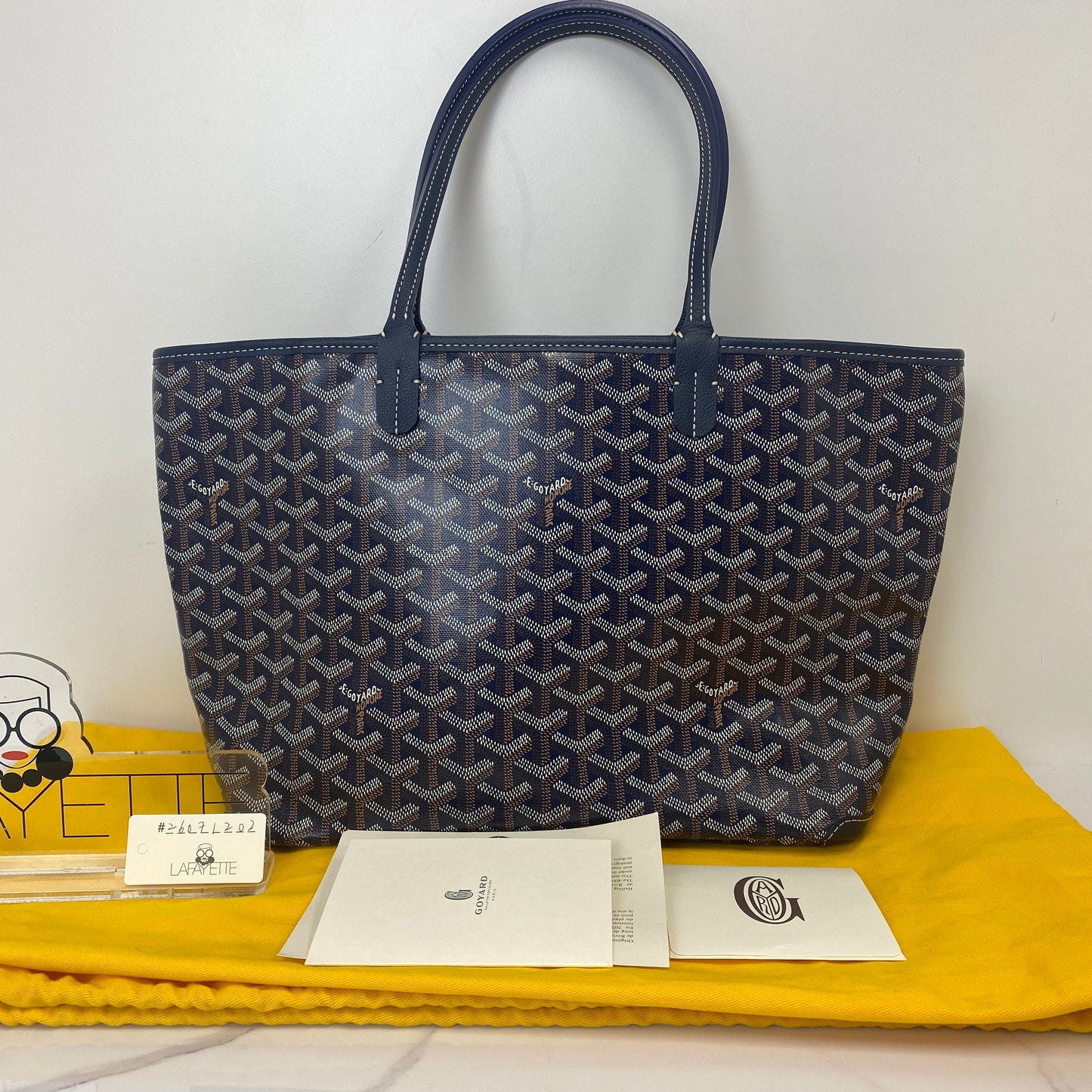 Goyard Artois PM shown with its yellow dustbag and booklet