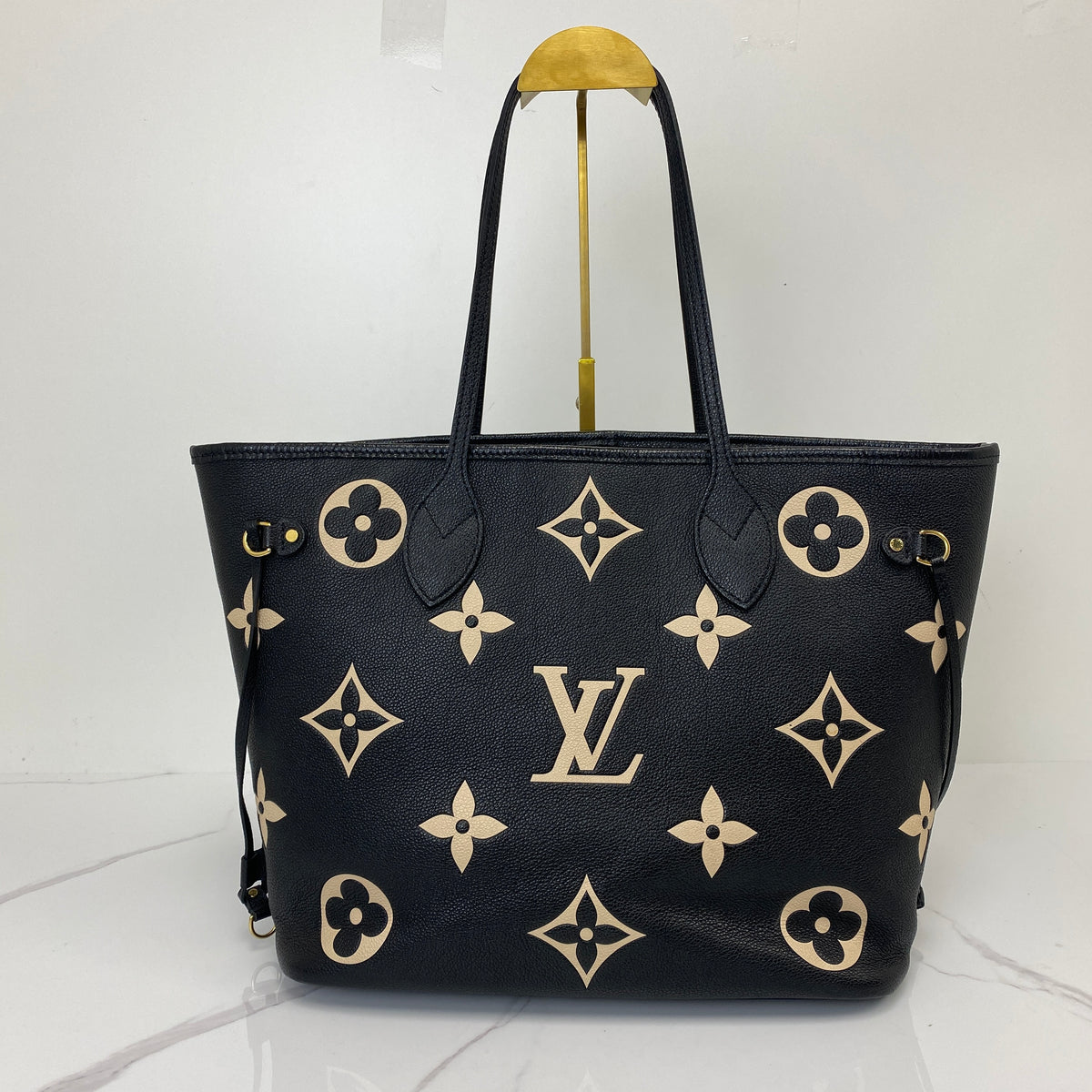 Louis Vuitton Neverfull MM, black Monogram Empreinte leather, gold-tone hardware — detail view 2