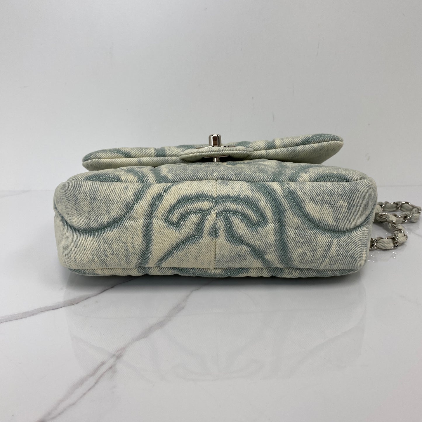 Base of the Chanel denim flap bag showing the printed pattern