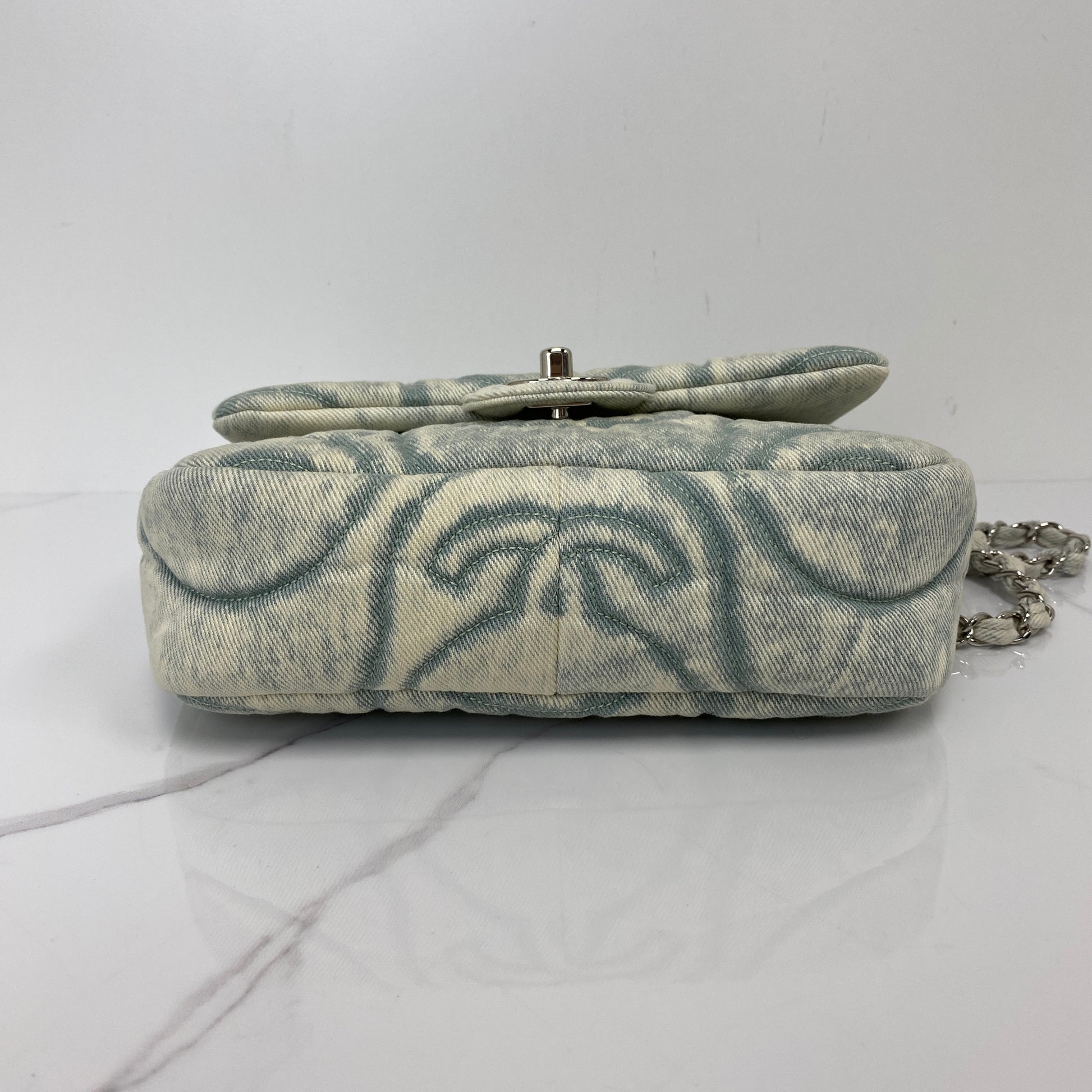 Base of the Chanel denim flap bag showing the printed pattern