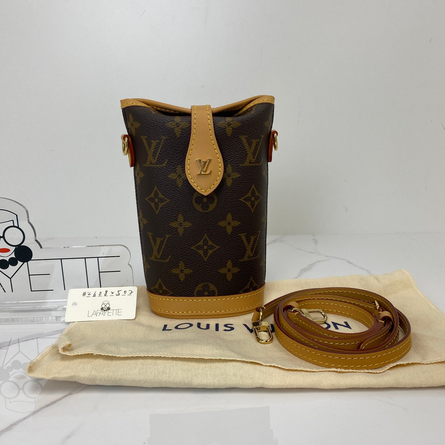 Louis Vuitton Fold Me Pouch shown with its included dustbag and strap