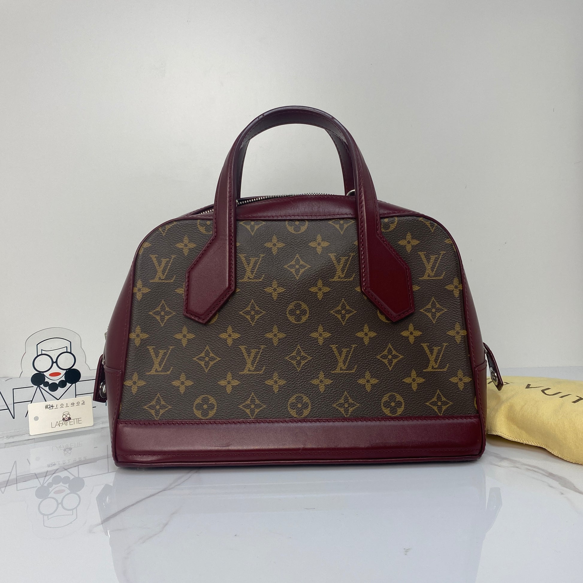 Louis Vuitton Dora Monogram PM with burgundy calfskin trim and rounded top handles