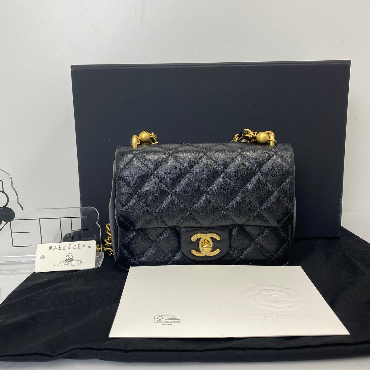 Chanel Pearl Twist Mini Classic Flap Bag, black lambskin, gold-tone hardware, pearl detail — detail view 1