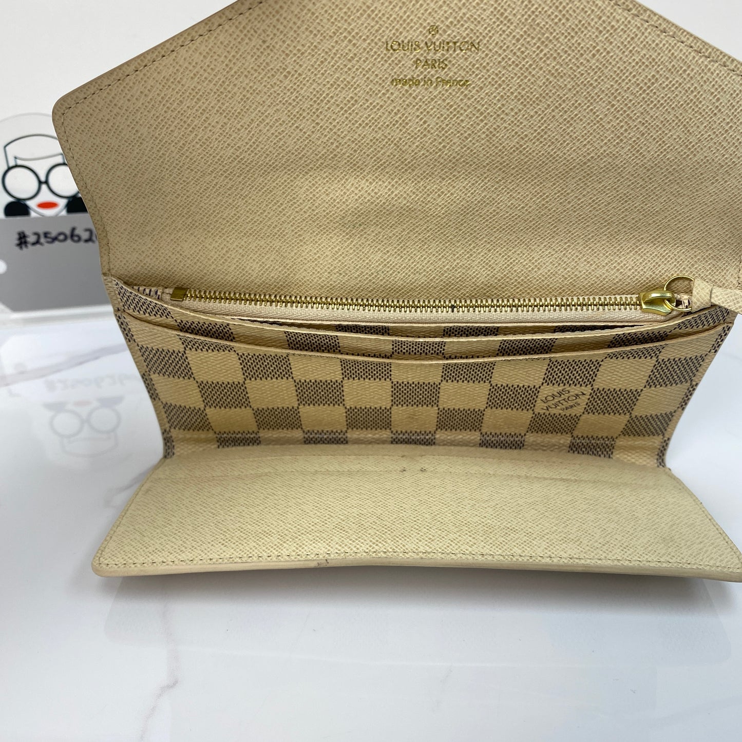 Louis Vuitton Sarah Wallet open showing the billfold compartment