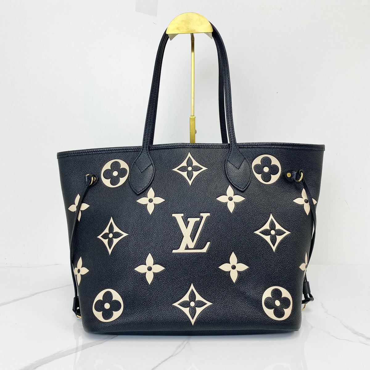 Louis Vuitton Neverfull MM, black Monogram Empreinte leather, gold-tone hardware — front view