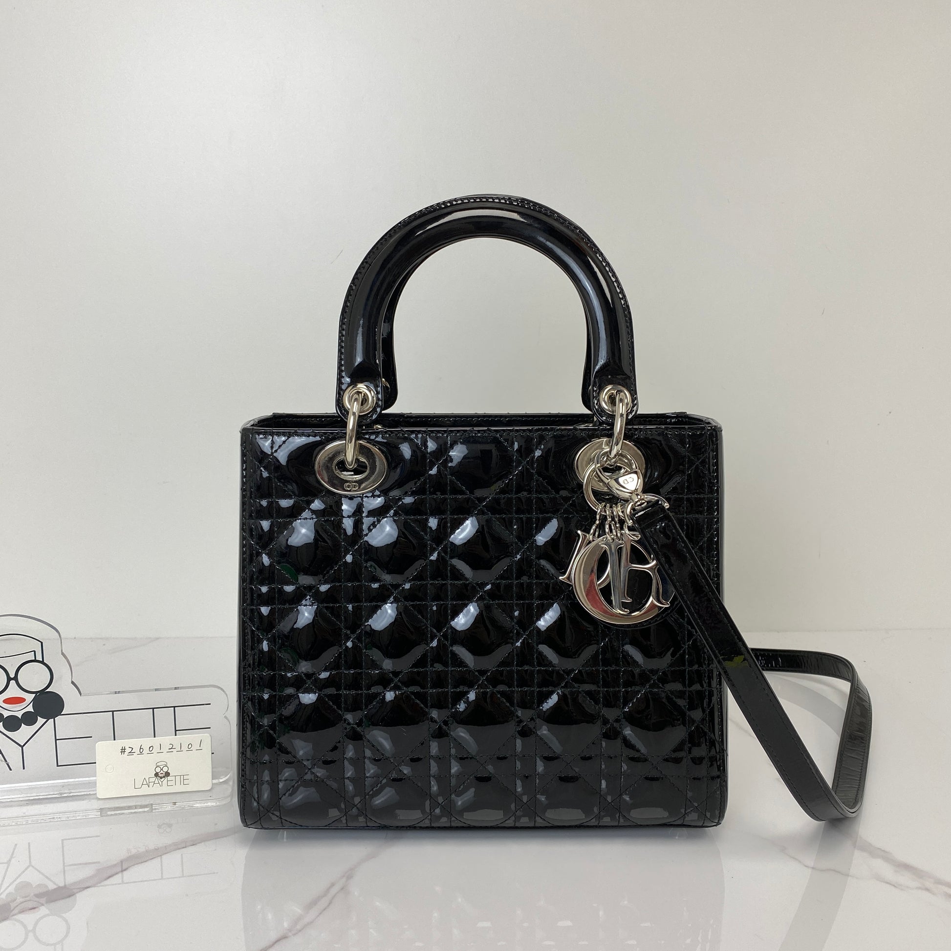 Medium Lady Dior shown with its D.I.O.R. charms and included strap