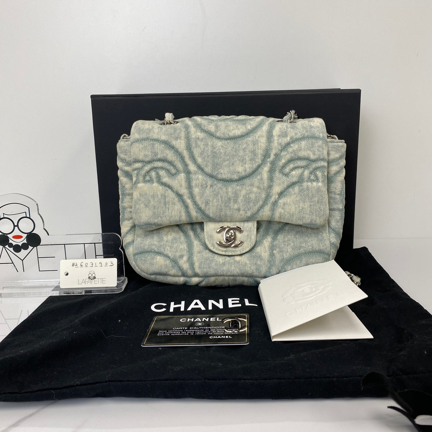 Chanel denim flap bag shown with its box, dustbag and authenticity card