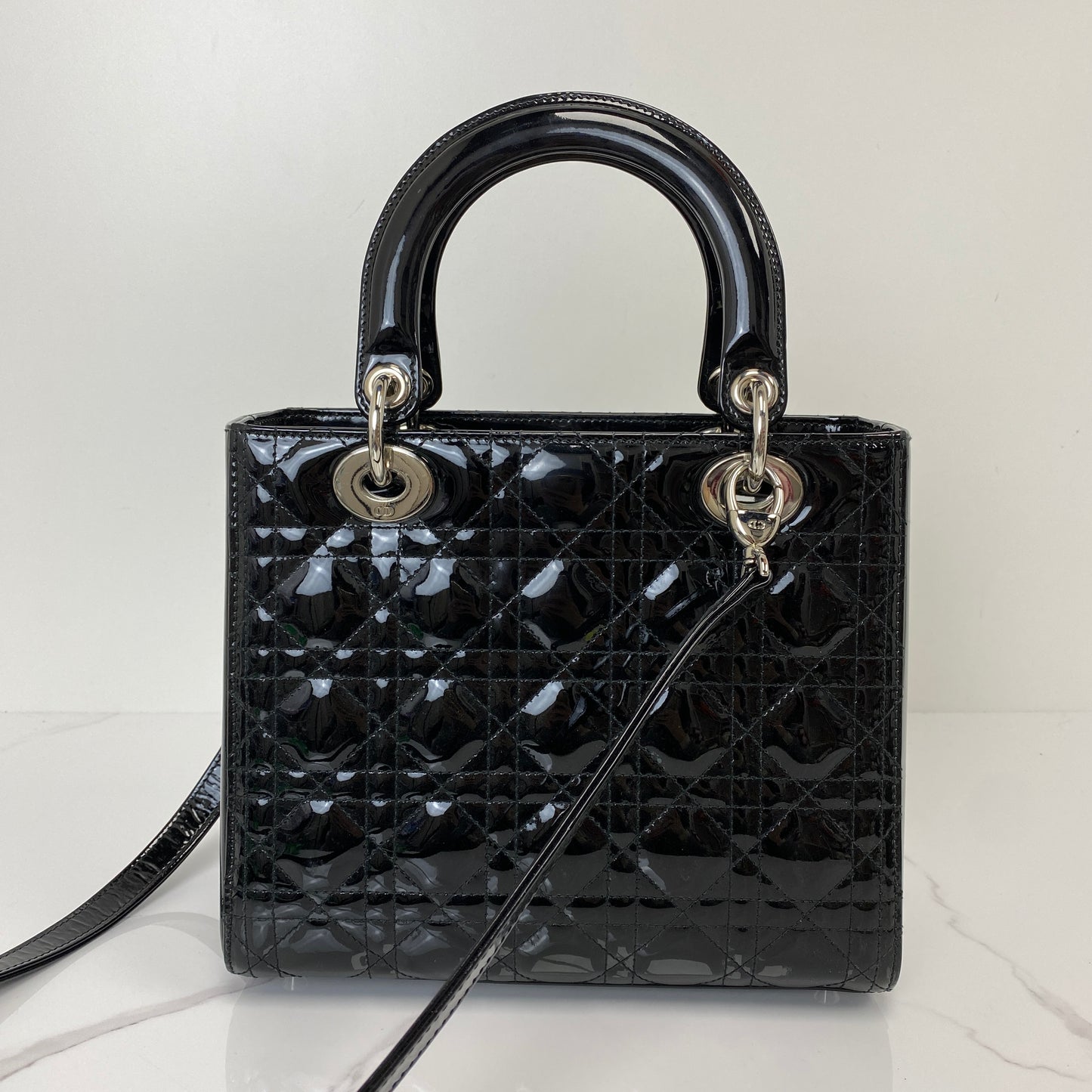 Front view of the black patent Lady Dior showing the quilted Cannage pattern