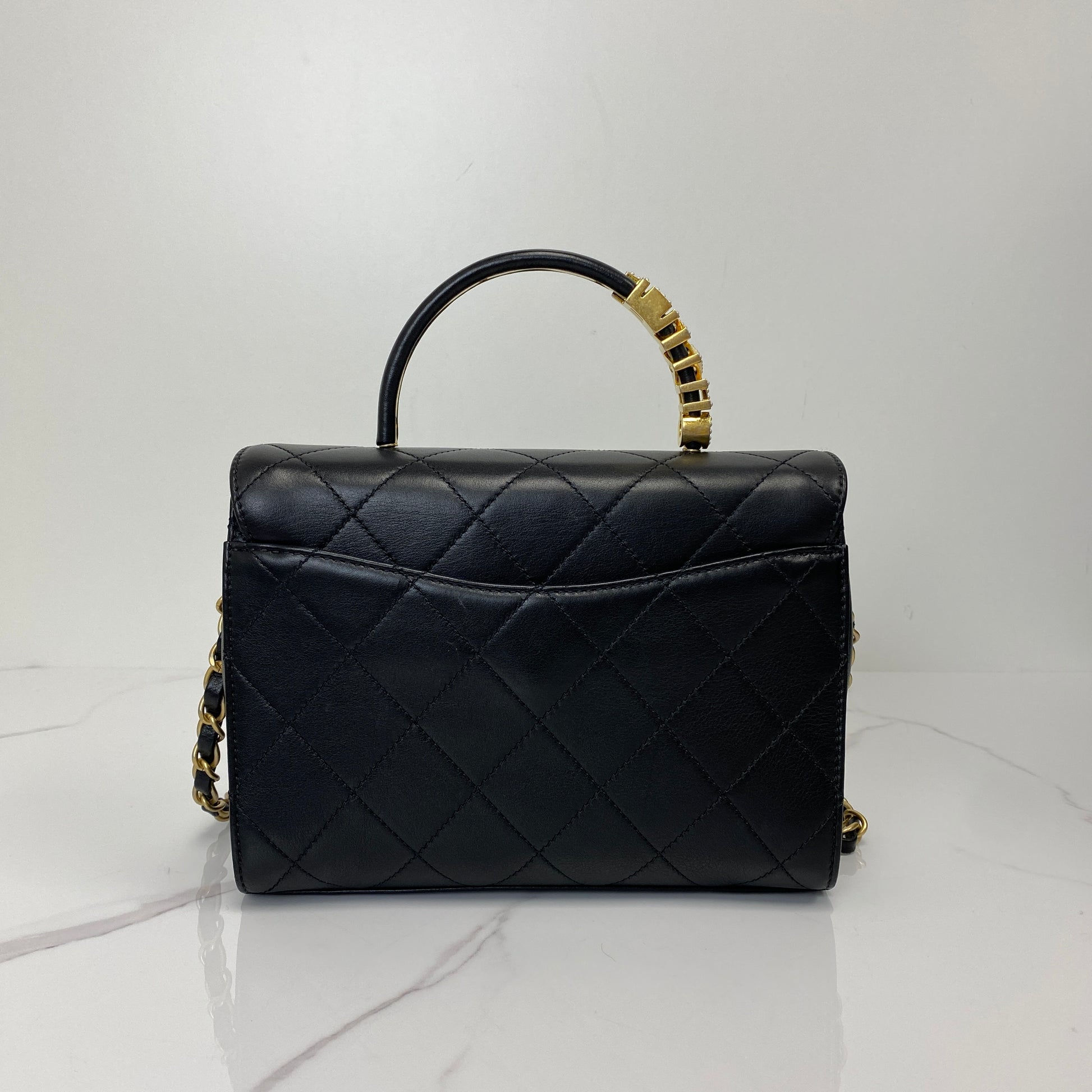 Back view of the black Chanel top handle flap bag