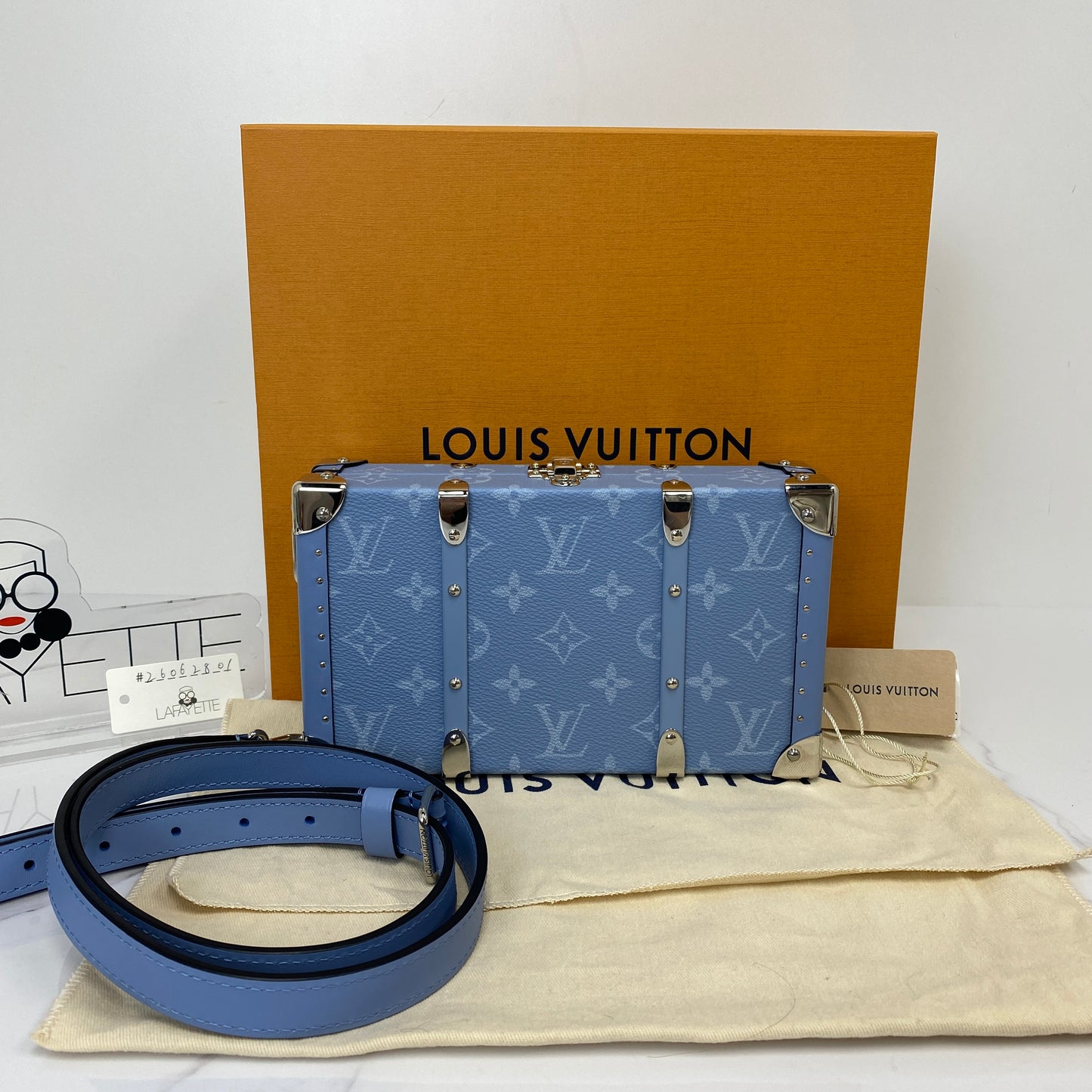 Louis Vuitton Wallet Trunk shown with its box, dustbag, strap and retail tag