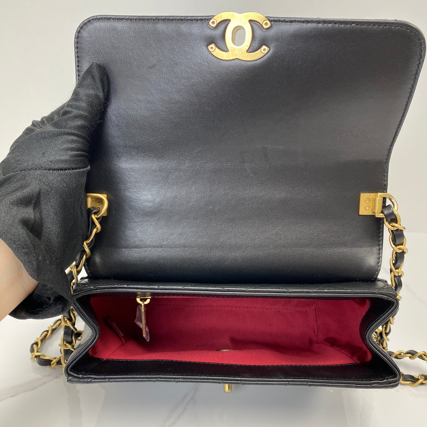Interior of the Chanel flap bag showing the burgundy lining and CC flap