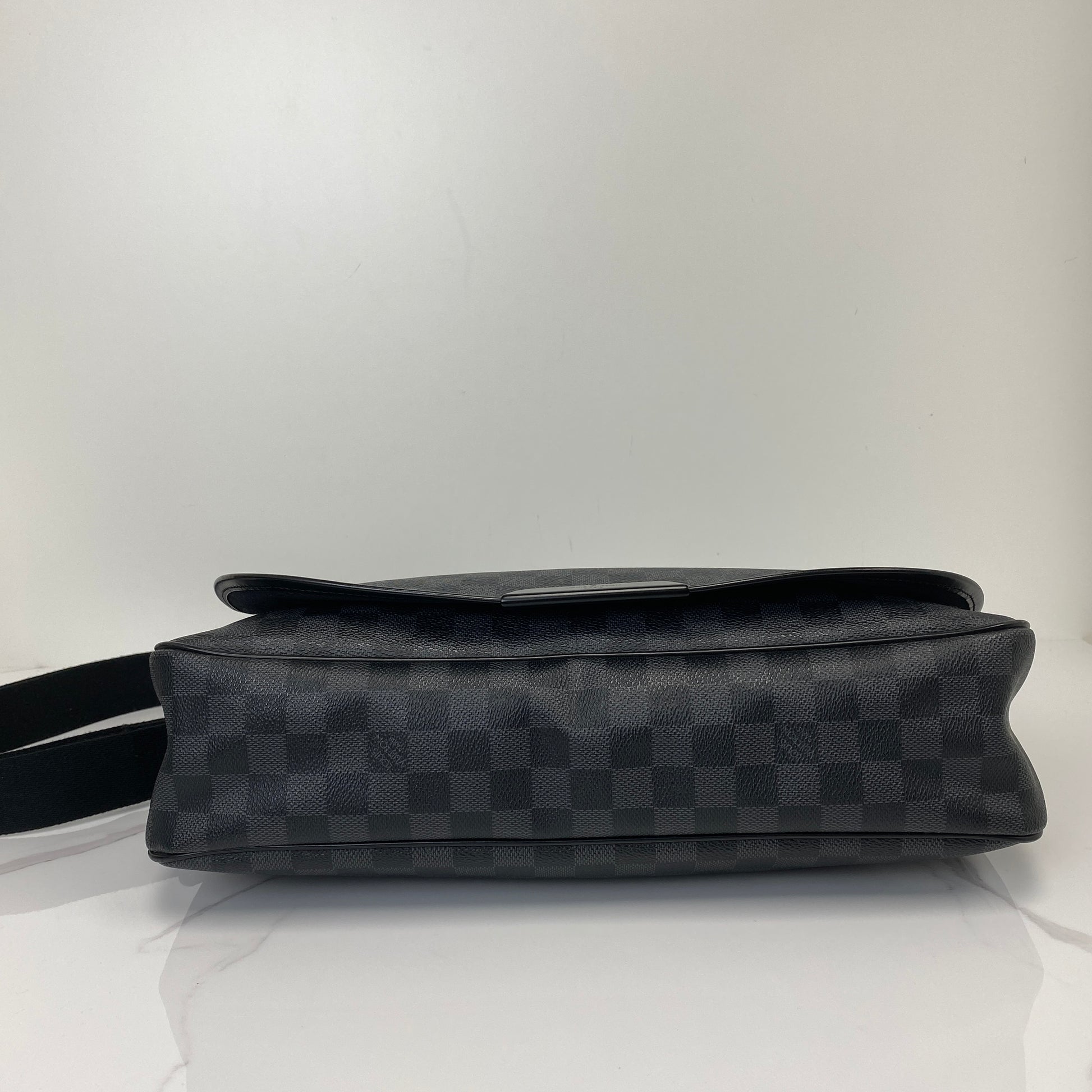 Side profile of the Damier Graphite messenger with adjustable strap