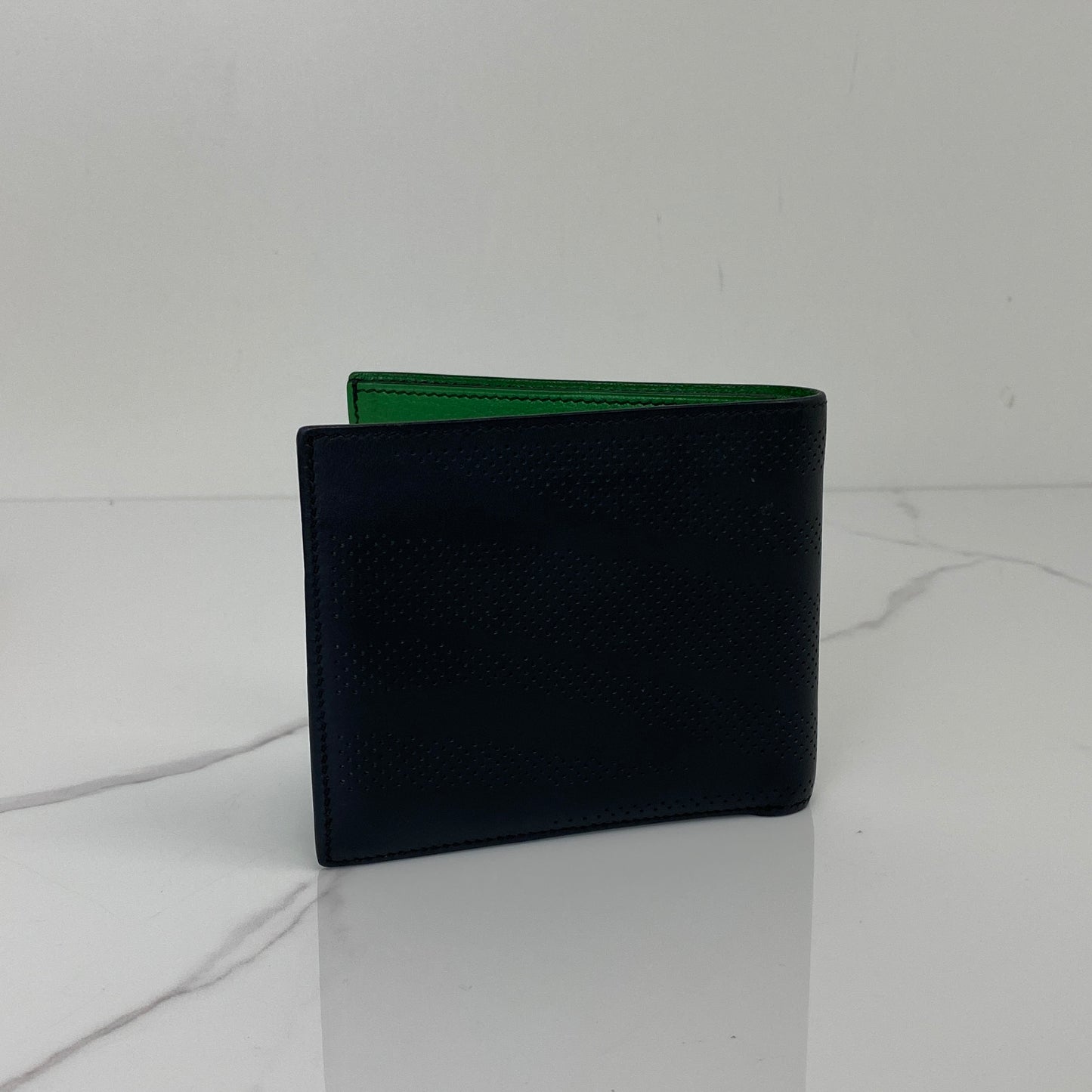 Closed view of the black Hermès MC2 Copernic bifold wallet