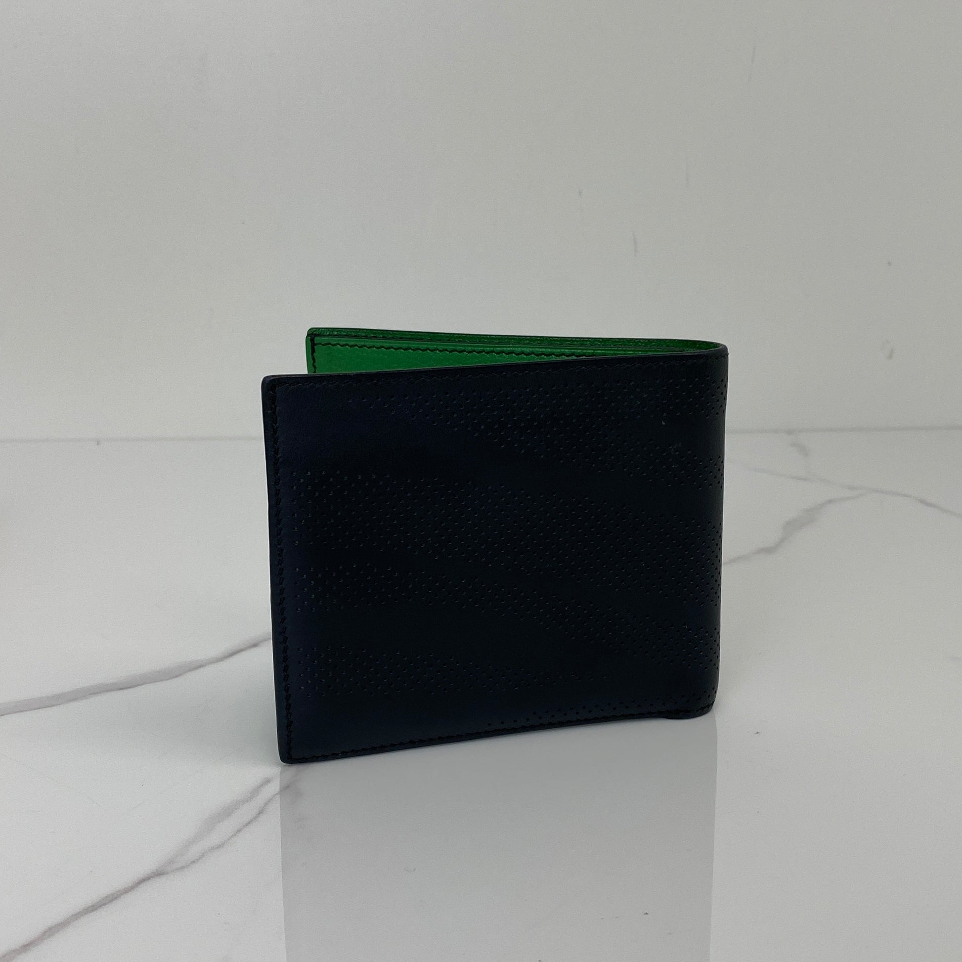 Closed view of the black Hermès MC2 Copernic bifold wallet