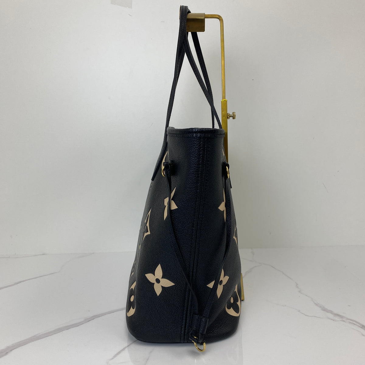 Louis Vuitton Neverfull MM, black Monogram Empreinte leather, gold-tone hardware — detail view 1