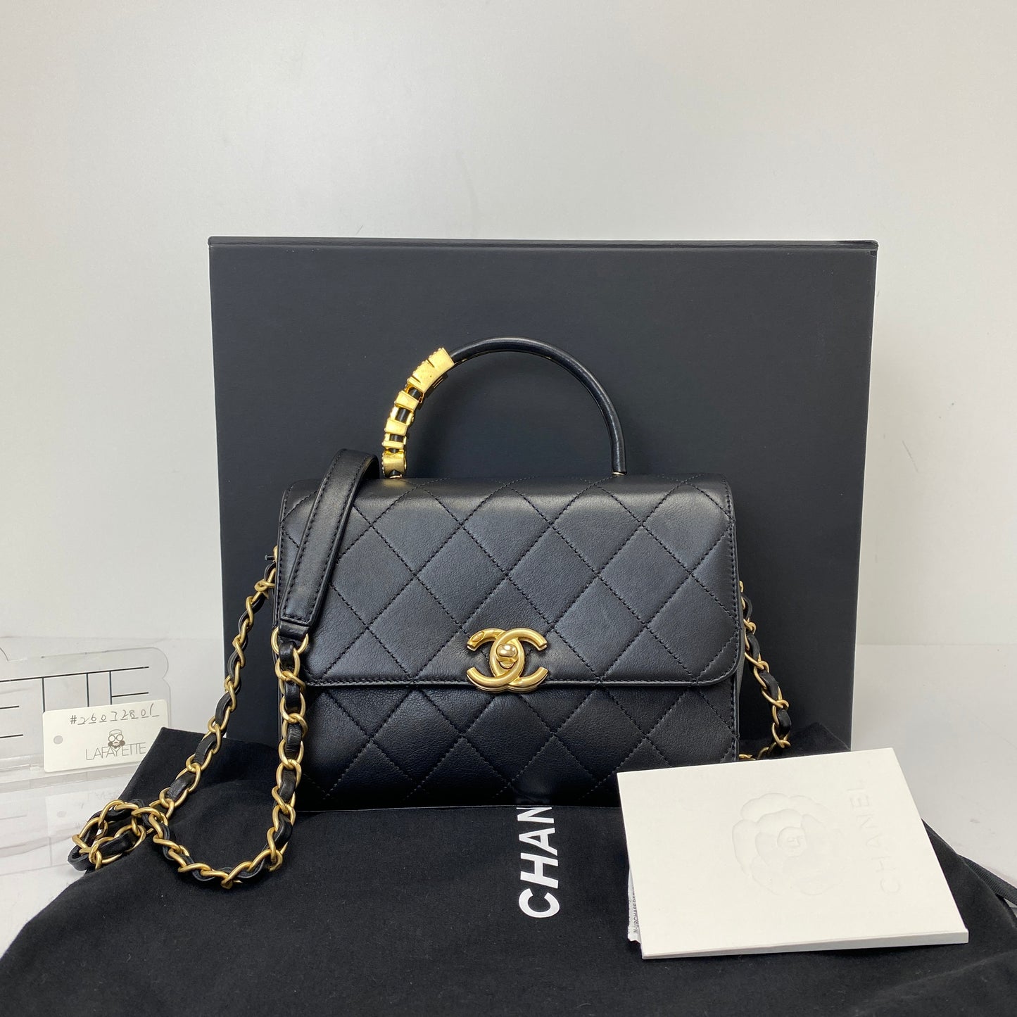 Chanel top handle flap bag shown with its box, dustbag and authenticity card